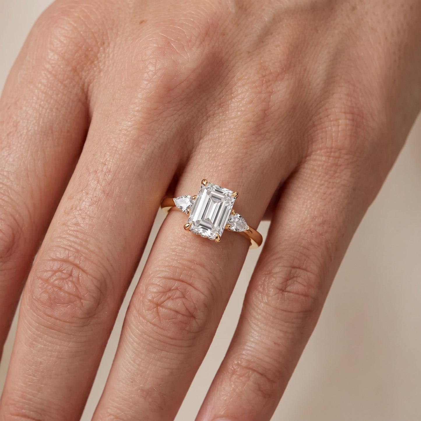 Leila Three-Stone Emerald Diamond Engagement Ring in Yellow Gold - lifestyle.jpg