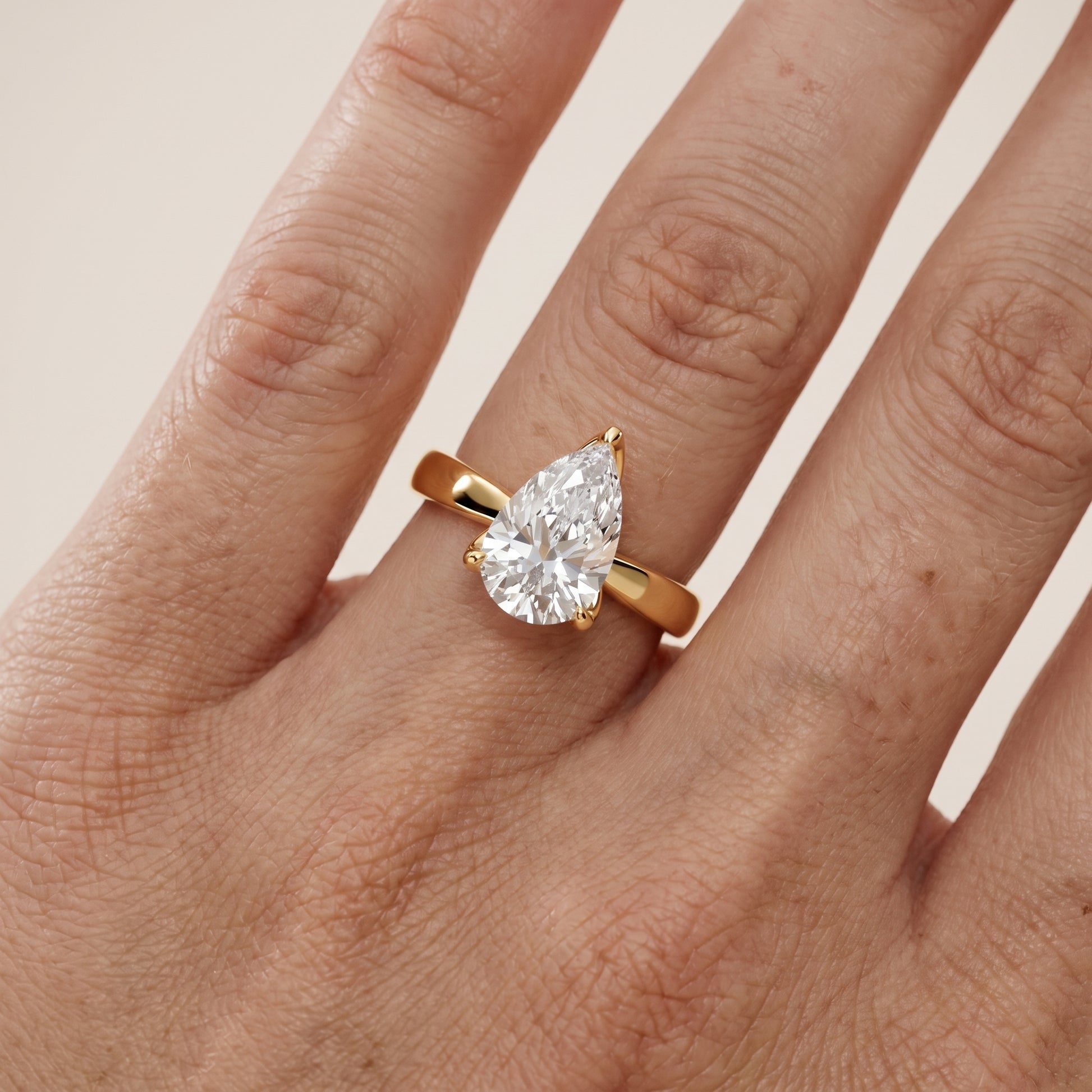 Lucia Solitaire Six-Prong Pear Diamond Engagement Ring in Yellow Gold - lifestyle.jpg