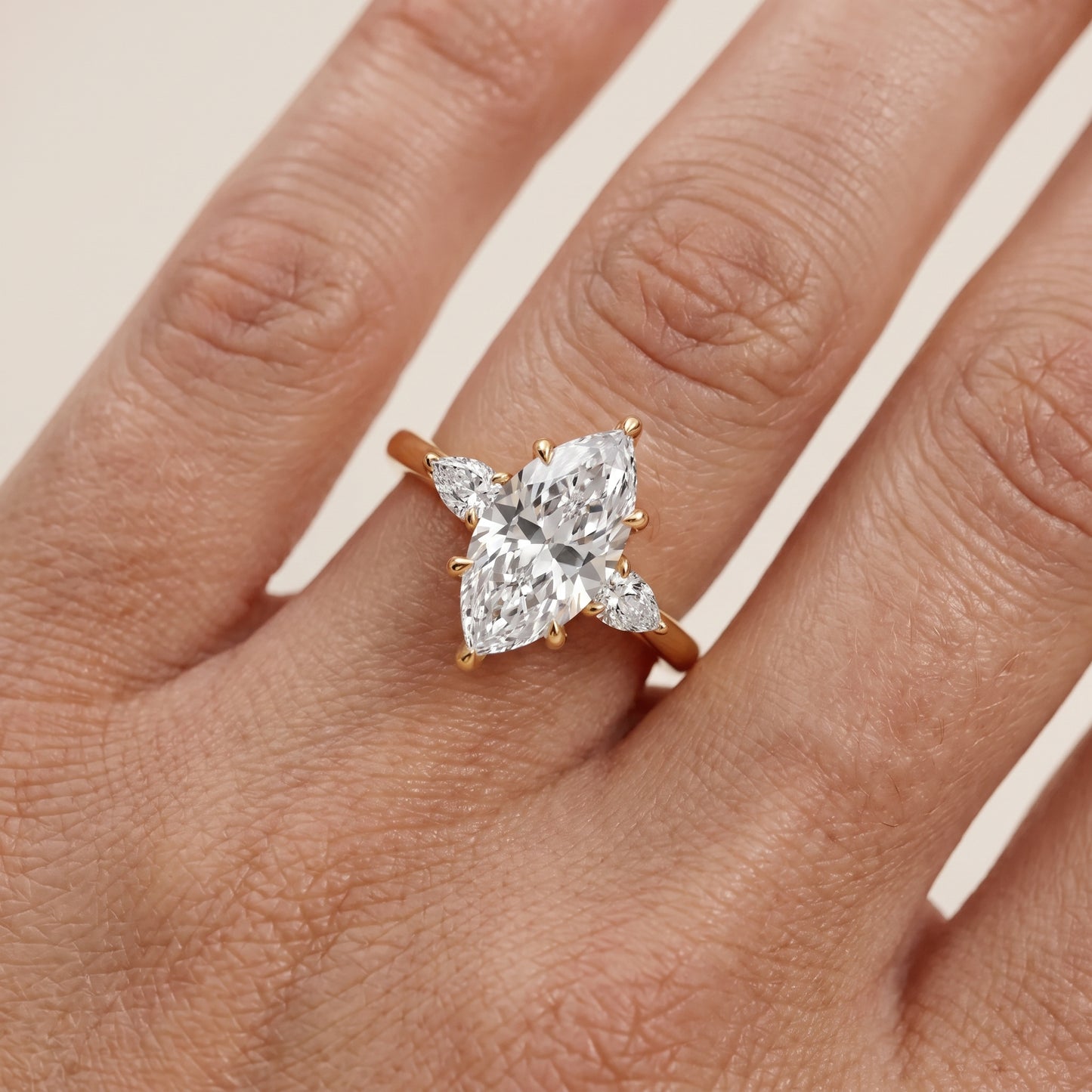 Leila Three-Stone Marquise Diamond Engagement Ring in Yellow Gold - lifestyle.jpg