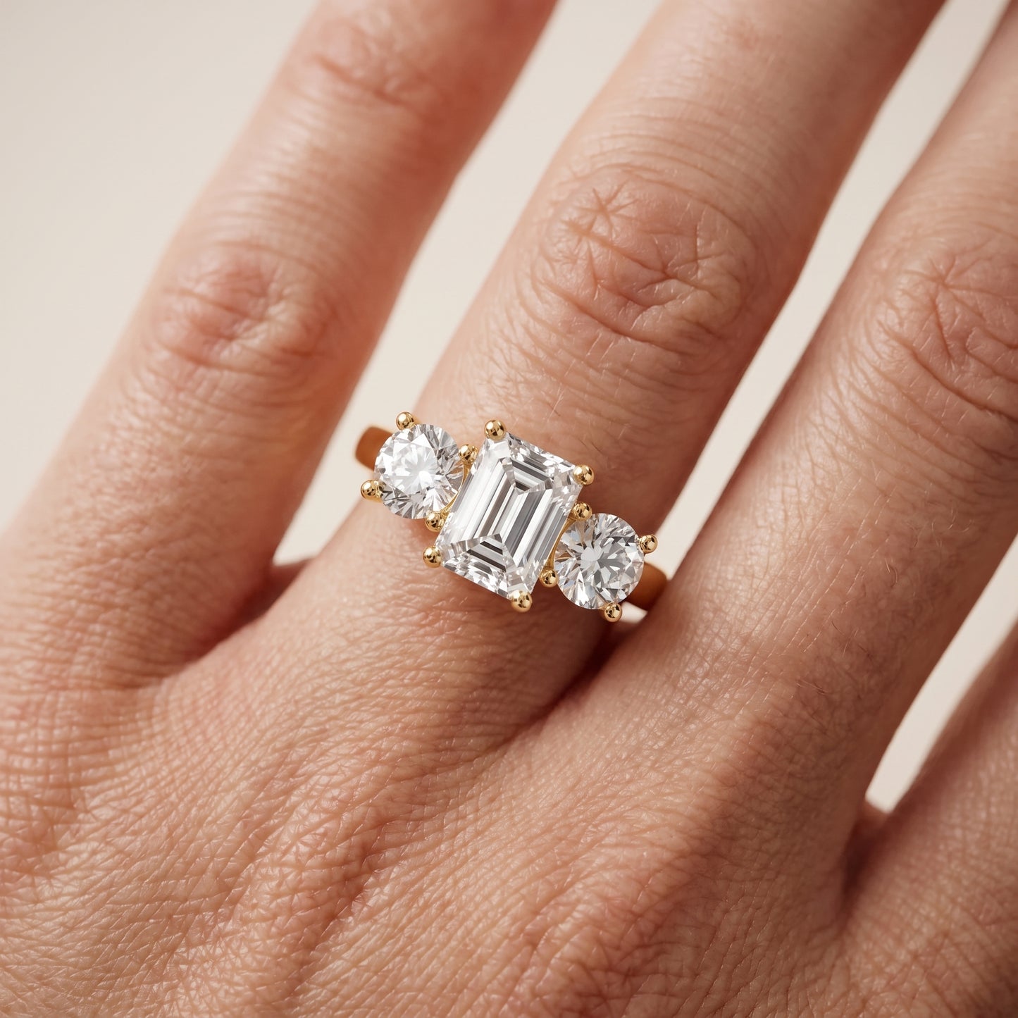 Callie Three-Stone Trellis Emerald Diamond Ring in Yellow Gold - lifestyle.jpg