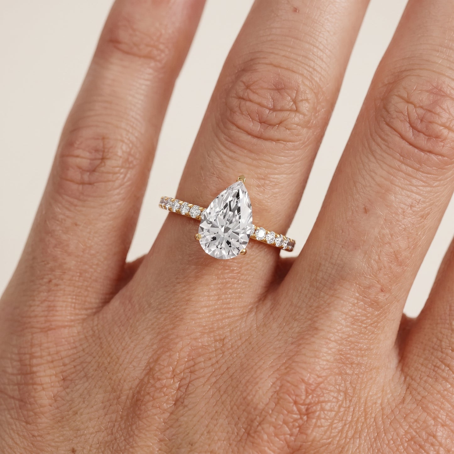 Juna French Pavé Solitaire Pear Diamond Engagement Ring in Yellow Gold - lifestyle.jpg