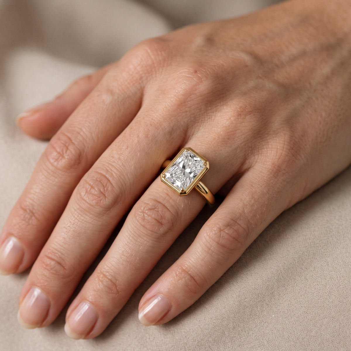 Alina Bezel Solitaire Radiant Diamond Engagement Ring in Yellow Gold - lifestyle.jpg