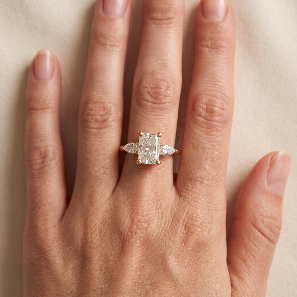 Faye Three-Stone Trellis Radiant Diamond Engagement Ring in Yellow Gold - lifestyle.jpg