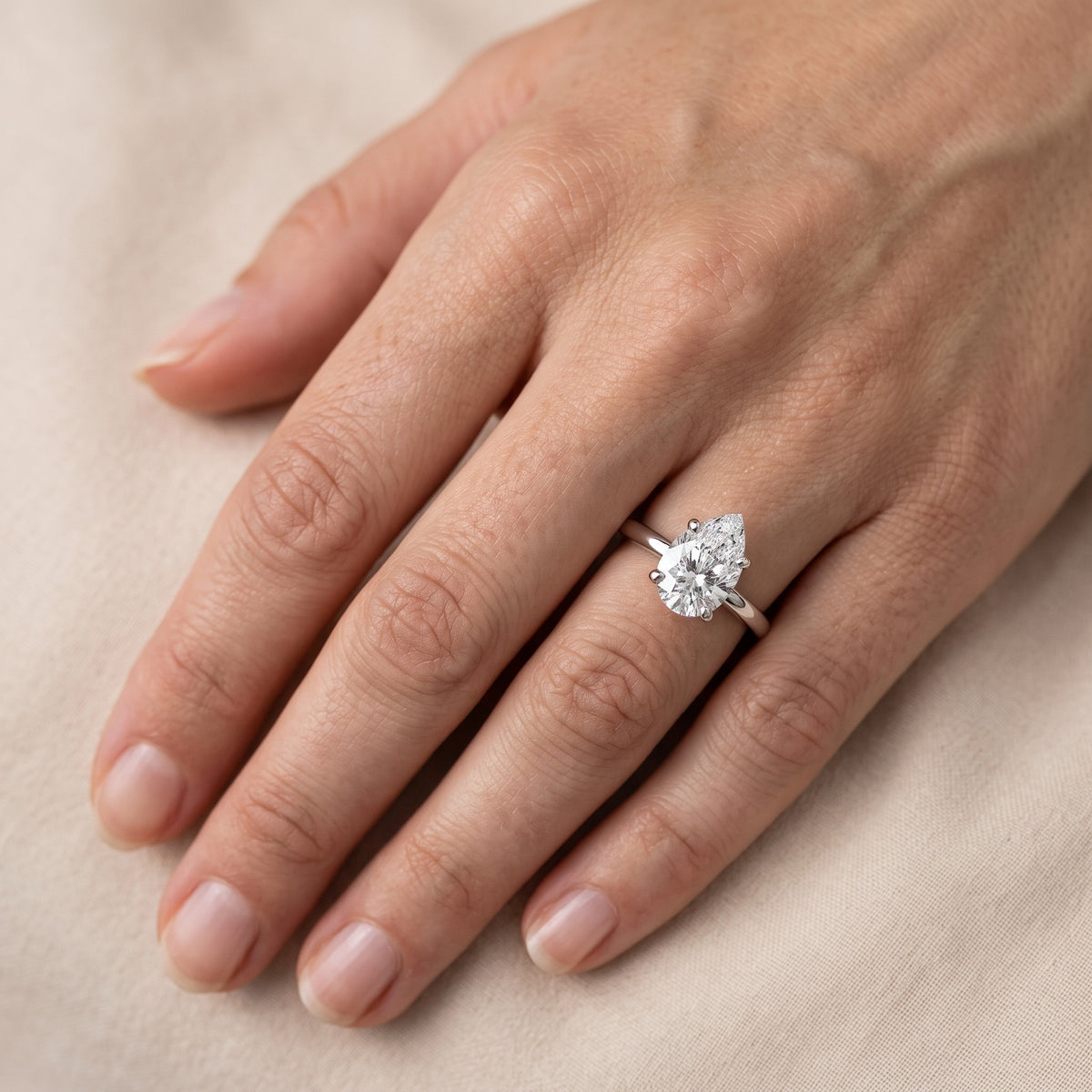 Charlotte Charm Solitaire Pear Diamond Engagement Ring in Silver - lifestyle.jpg