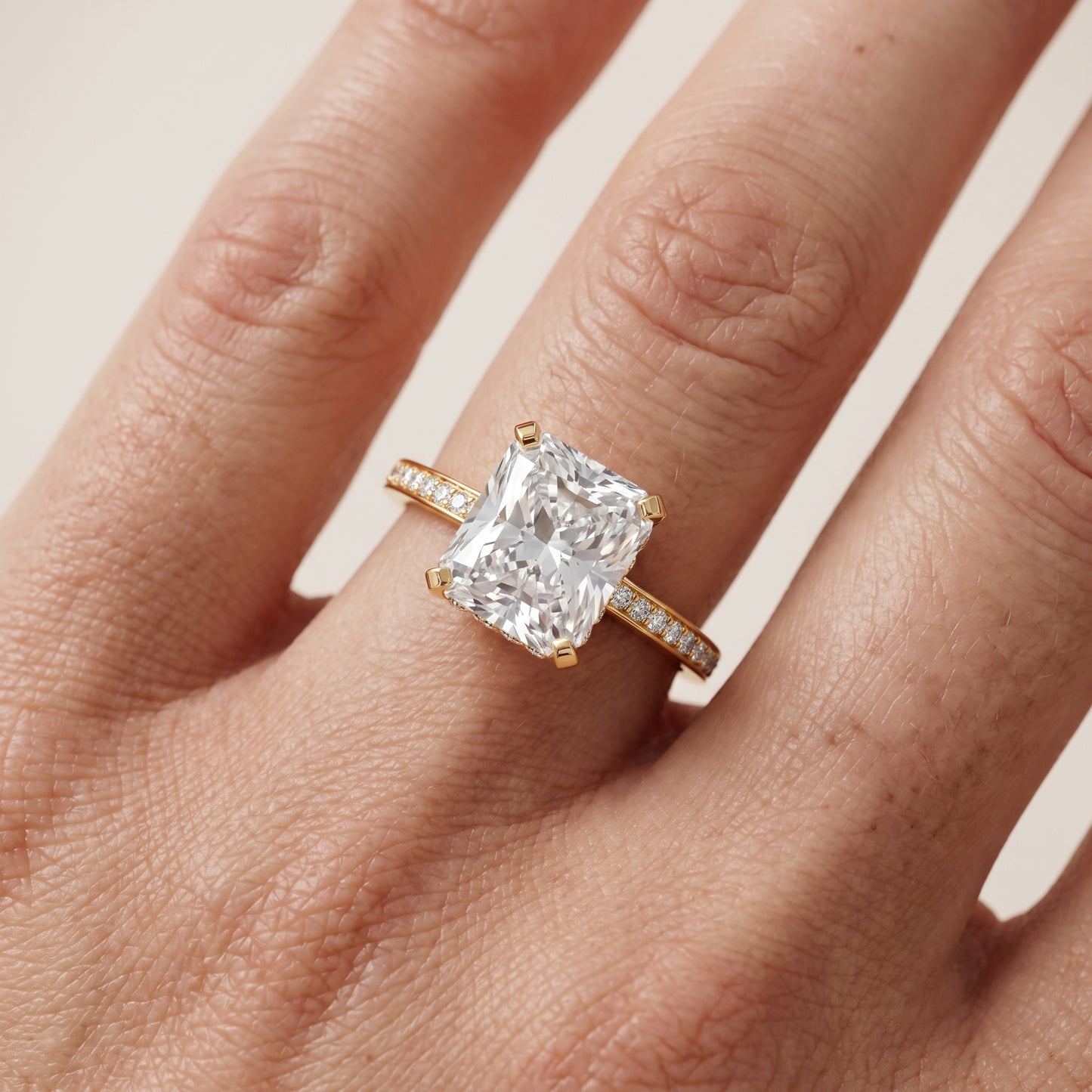 Naia Hidden Halo Radiant Diamond Ring in Yellow Gold - lifestyle.jpg