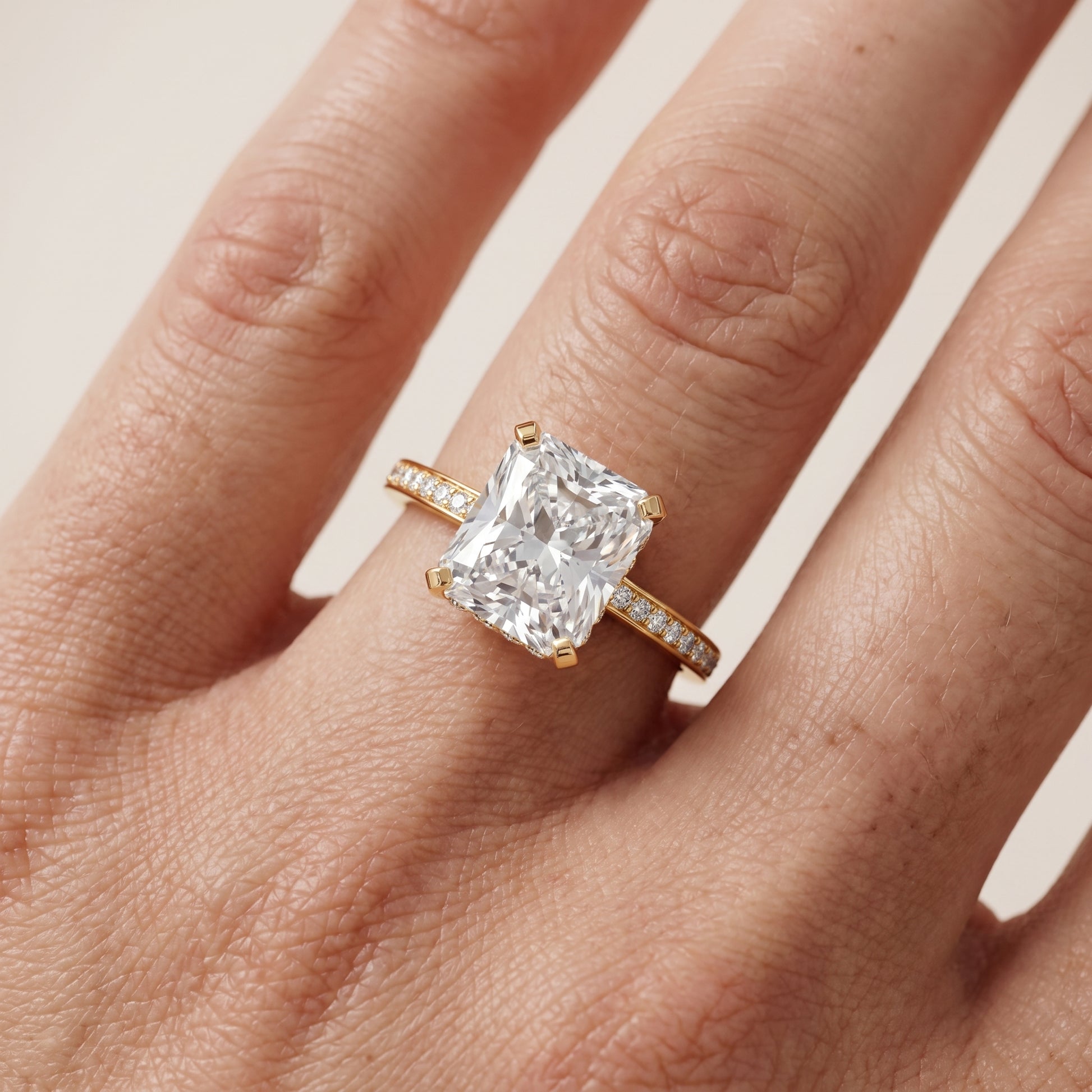 Naia Hidden Halo Radiant Diamond Ring in Yellow Gold - lifestyle.jpg