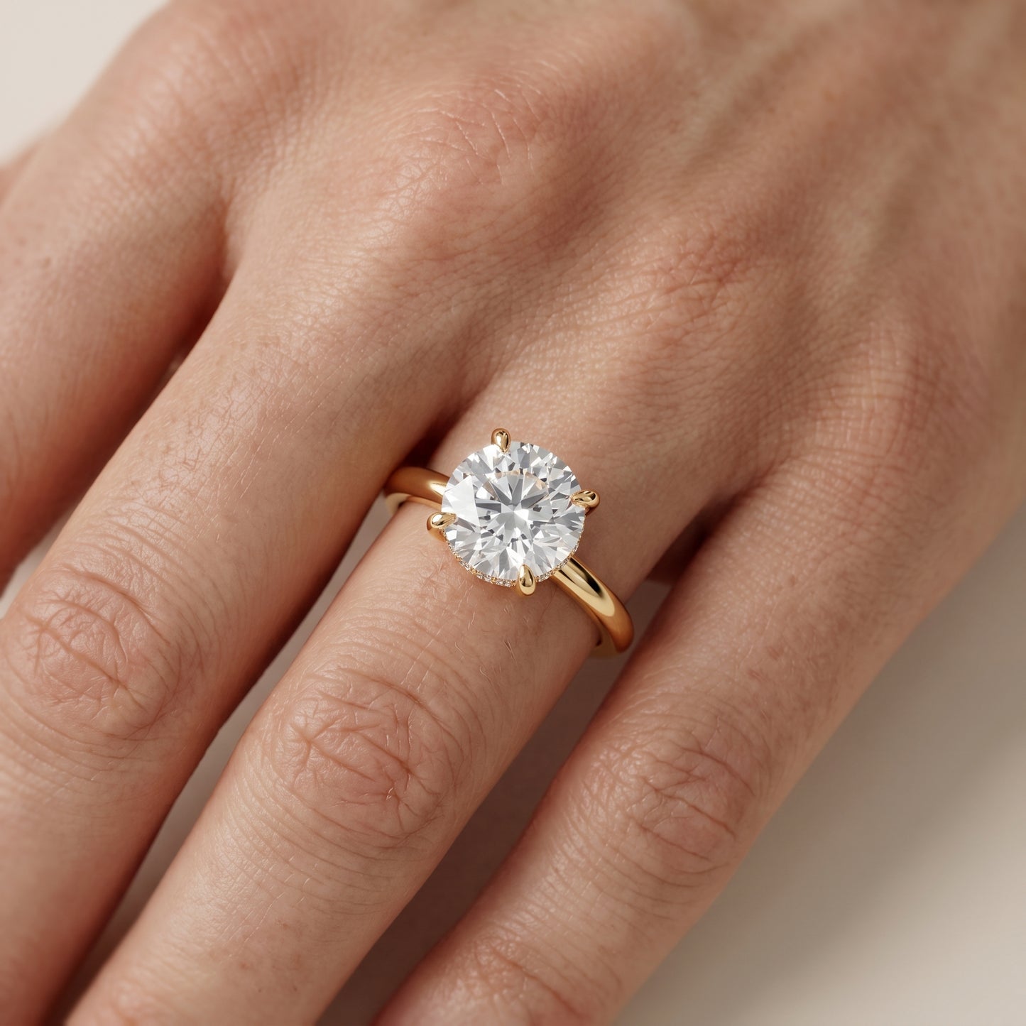 Amaya Hidden Halo Round Diamond Ring in Yellow Gold - lifestyle.jpg