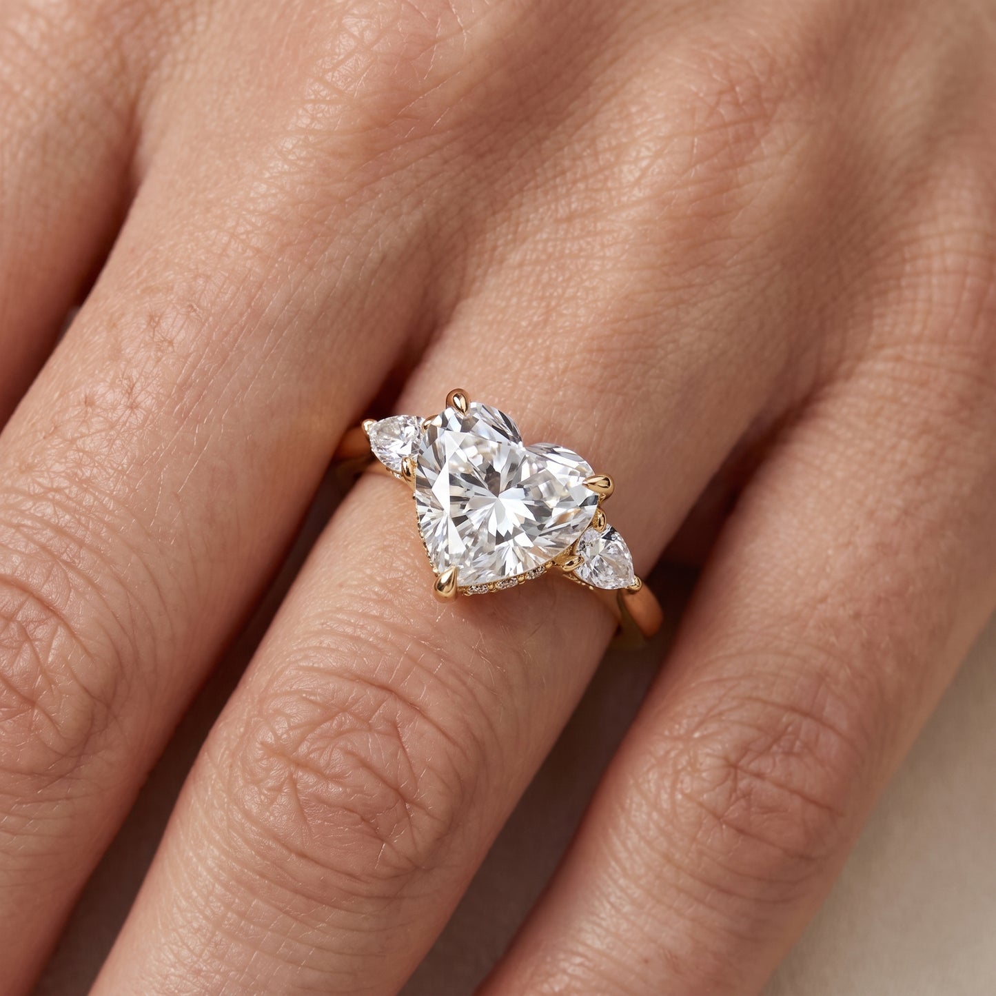 Leila Three-Stone Heart Diamond Engagement Ring in Yellow Gold - lifestyle.jpg