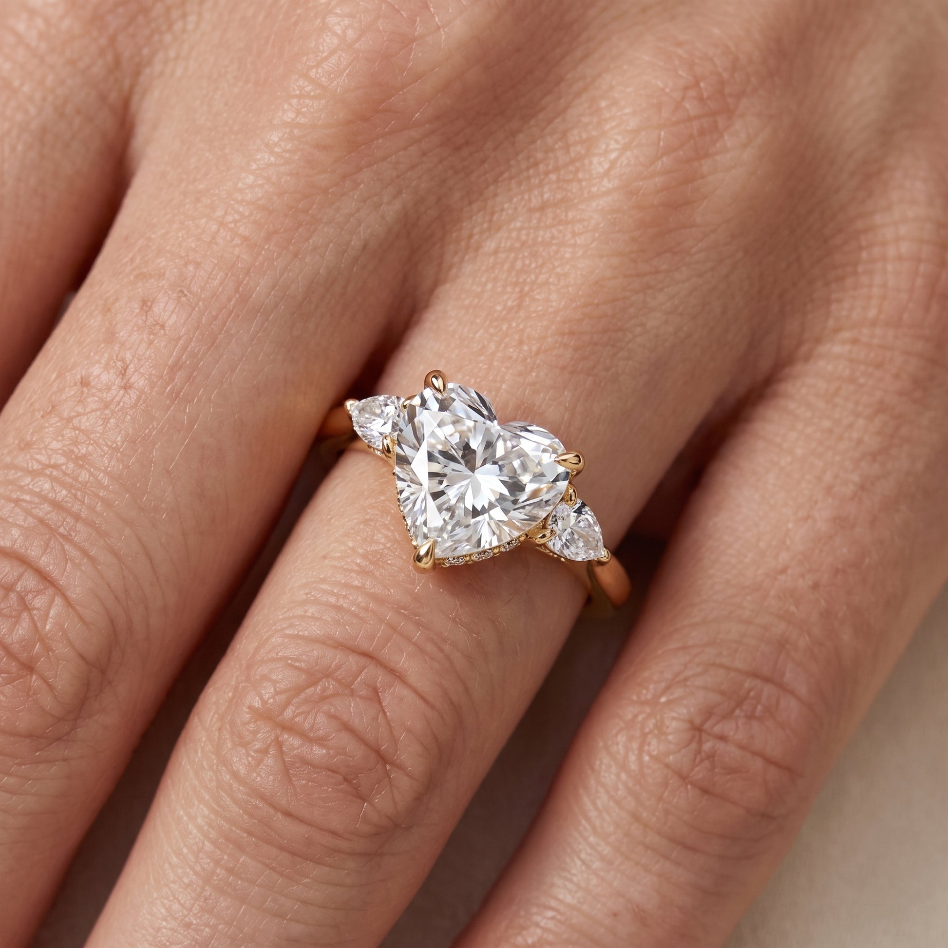 Leila Three-Stone Heart Diamond Engagement Ring in Yellow Gold - lifestyle.jpg