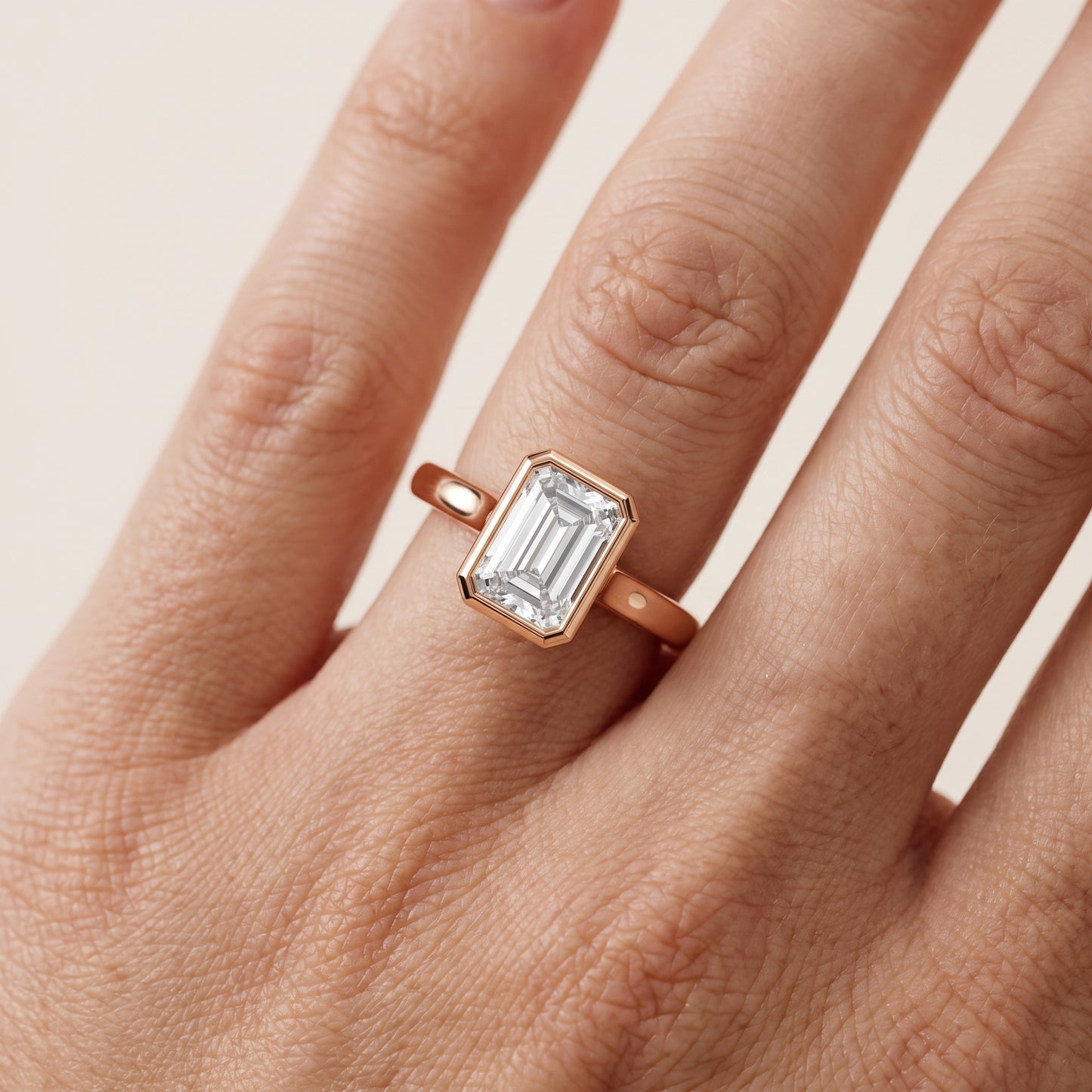 Jolie Bezel Solitaire Emerald Diamond Engagement Ring in Rose Gold - lifestyle.jpg