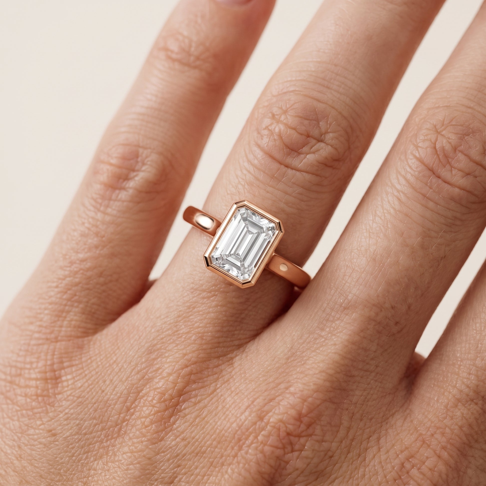 Jolie Bezel Solitaire Emerald Diamond Engagement Ring in Rose Gold - lifestyle.jpg