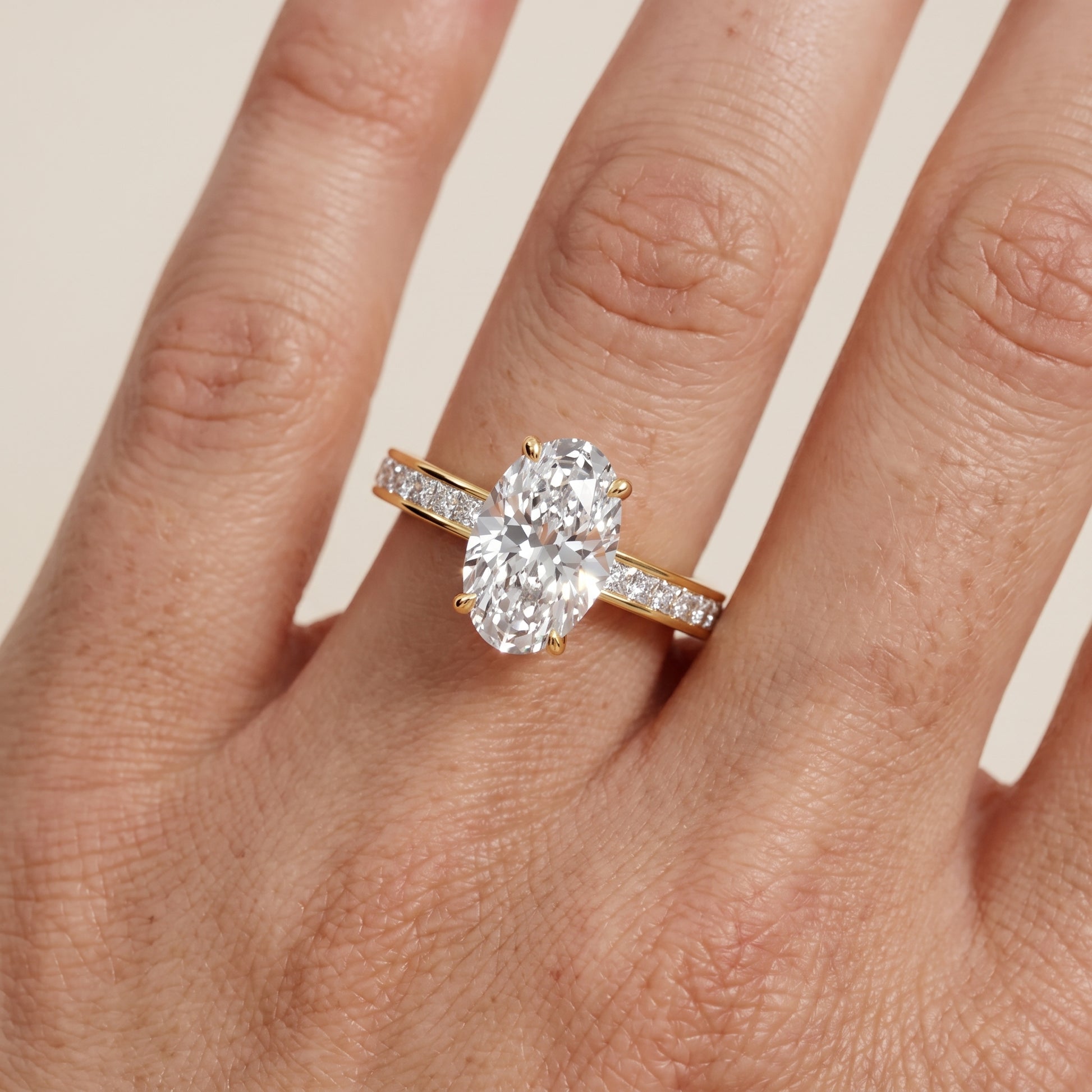 Brielle Channel Set Solitaire Oval Diamond Ring in Yellow Gold - lifestyle.jpg