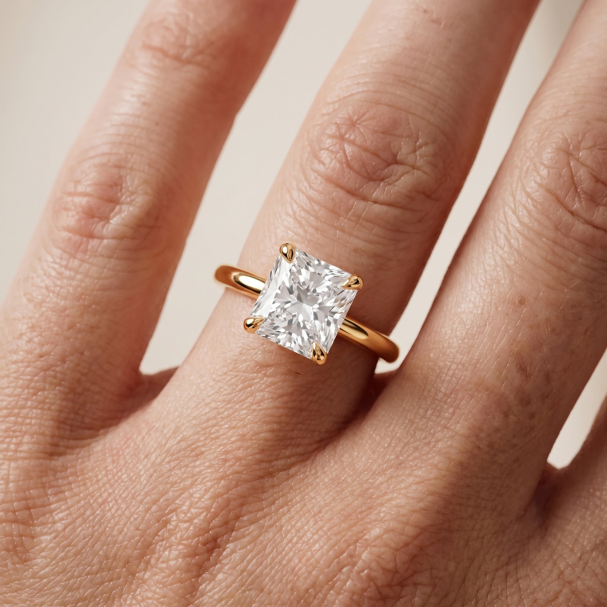 Nella Petite Solitaire Radiant Diamond Engagement Ring in Yellow Gold - lifestyle.jpg
