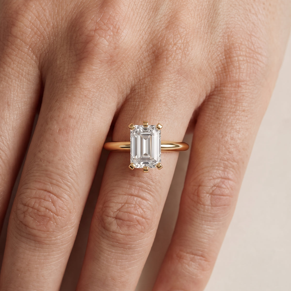 Arabella Six-Prong Solitaire Emerald Diamond Engagement Ring in Yellow Gold - lifestyle.jpg