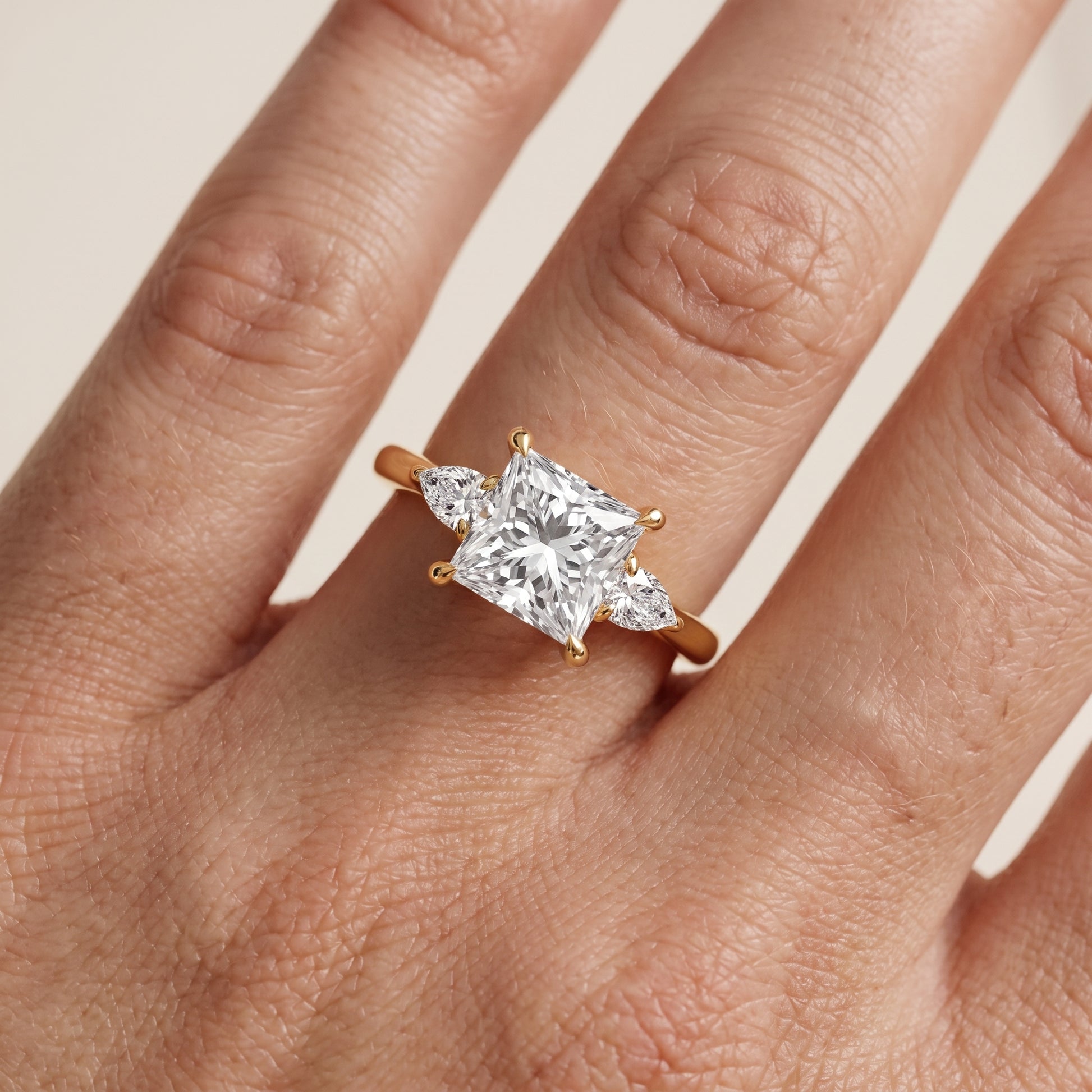 Leila Three-Stone Princess Diamond Engagement Ring in Yellow Gold - lifestyle.jpg