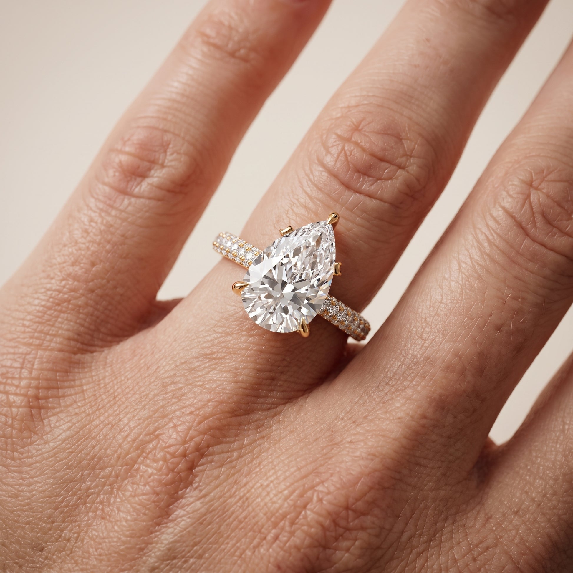 Della Hidden Halo Pavé Pear Diamond Engagement Ring in Yellow Gold - lifestyle.jpg