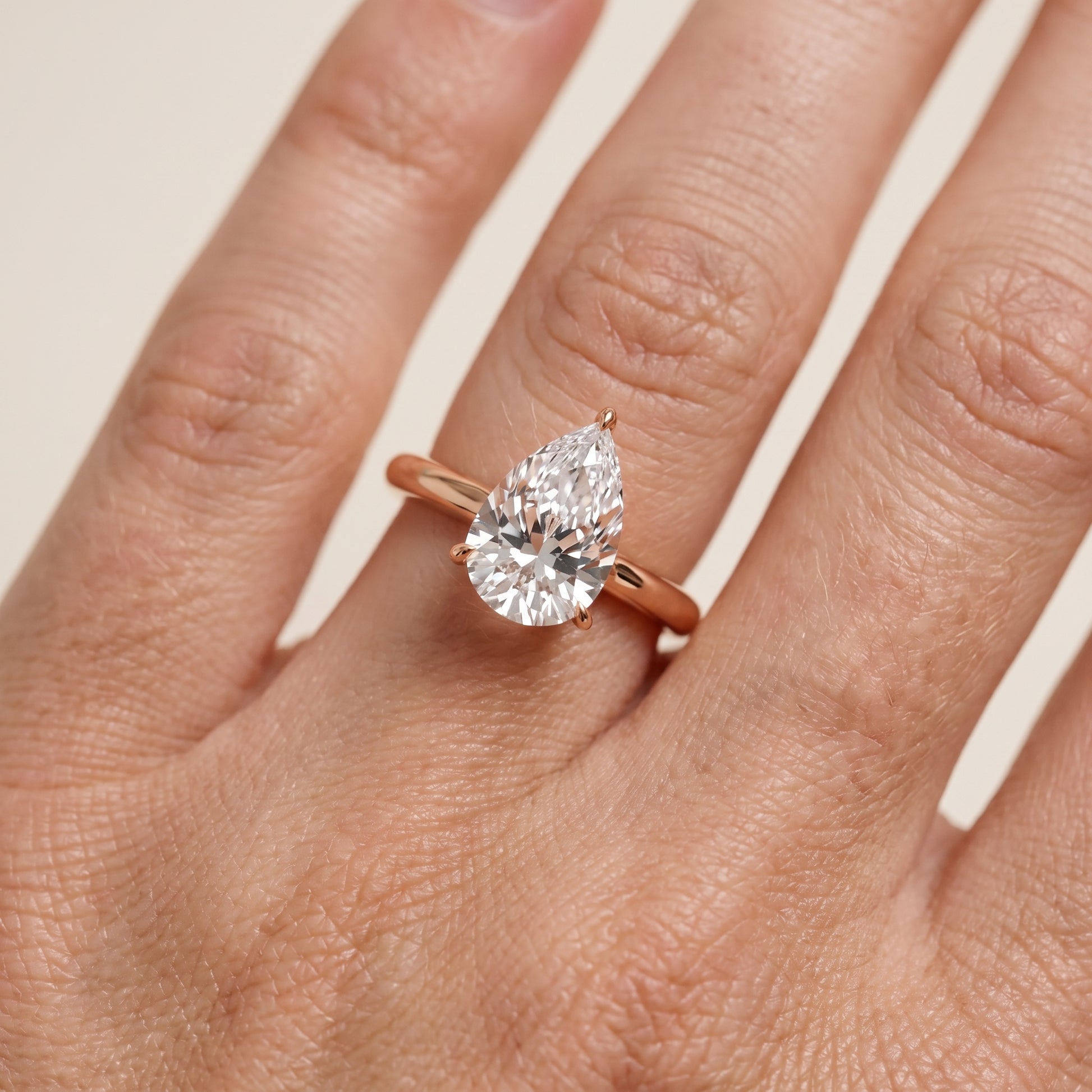 Evie Solitaire Six-Prong Pear Diamond Engagement Ring in Rose Gold - lifestyle.jpg