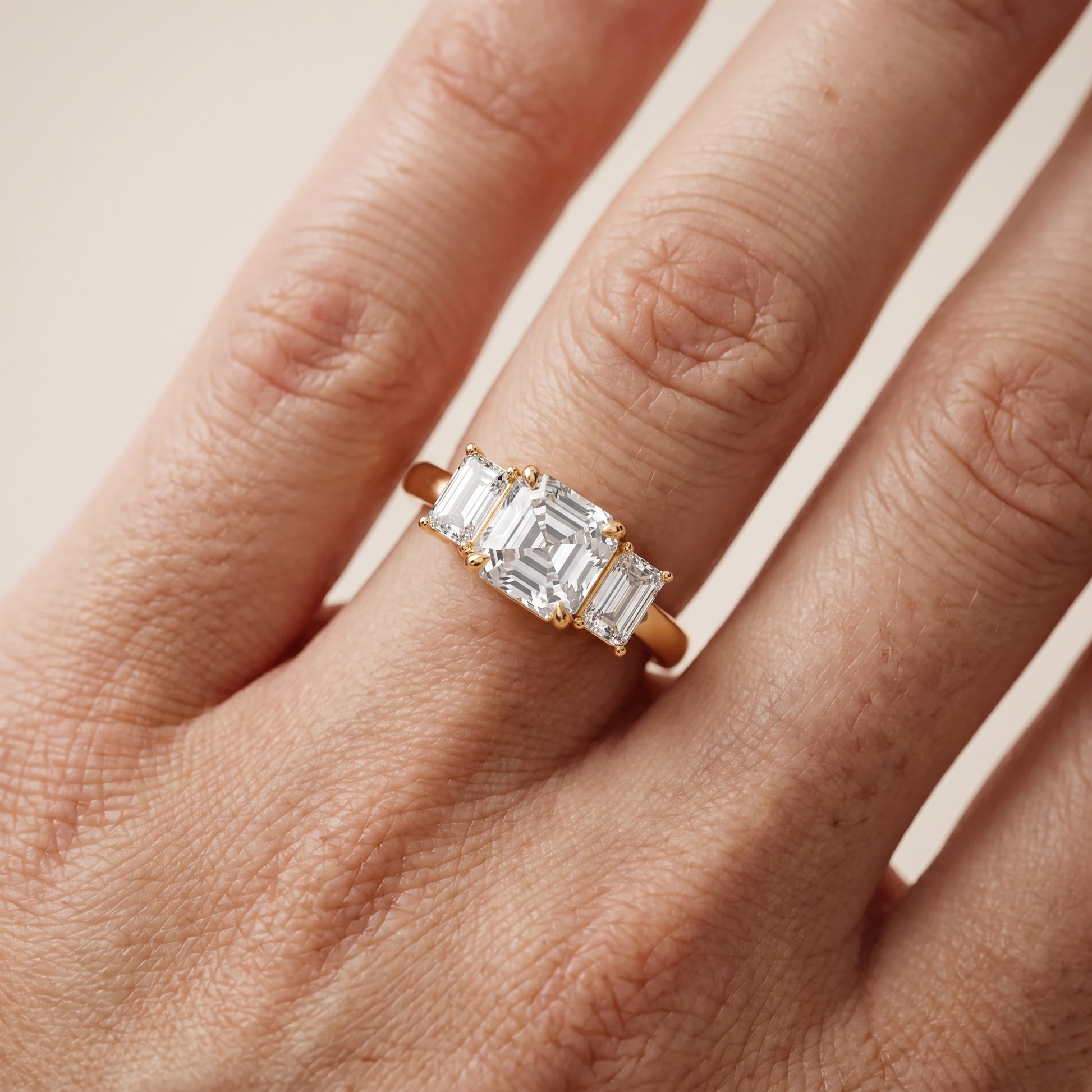 Zoe Three-Stone Asscher Diamond Ring in Yellow Gold - lifestyle.jpg