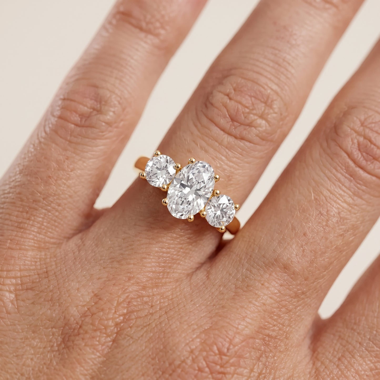 Callie Three-Stone Trellis Oval Diamond Engagement Ring in Yellow Gold - lifestyle.jpg