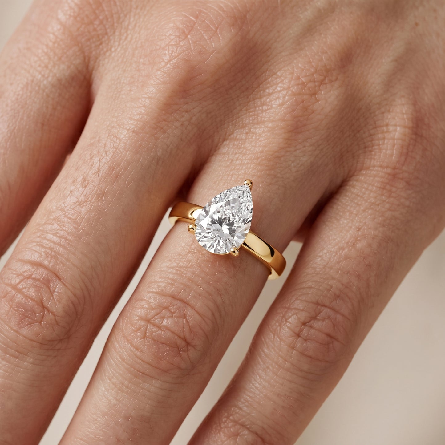 Delia Solitaire Pear Diamond Engagement Ring in Yellow Gold - lifestyle.jpg