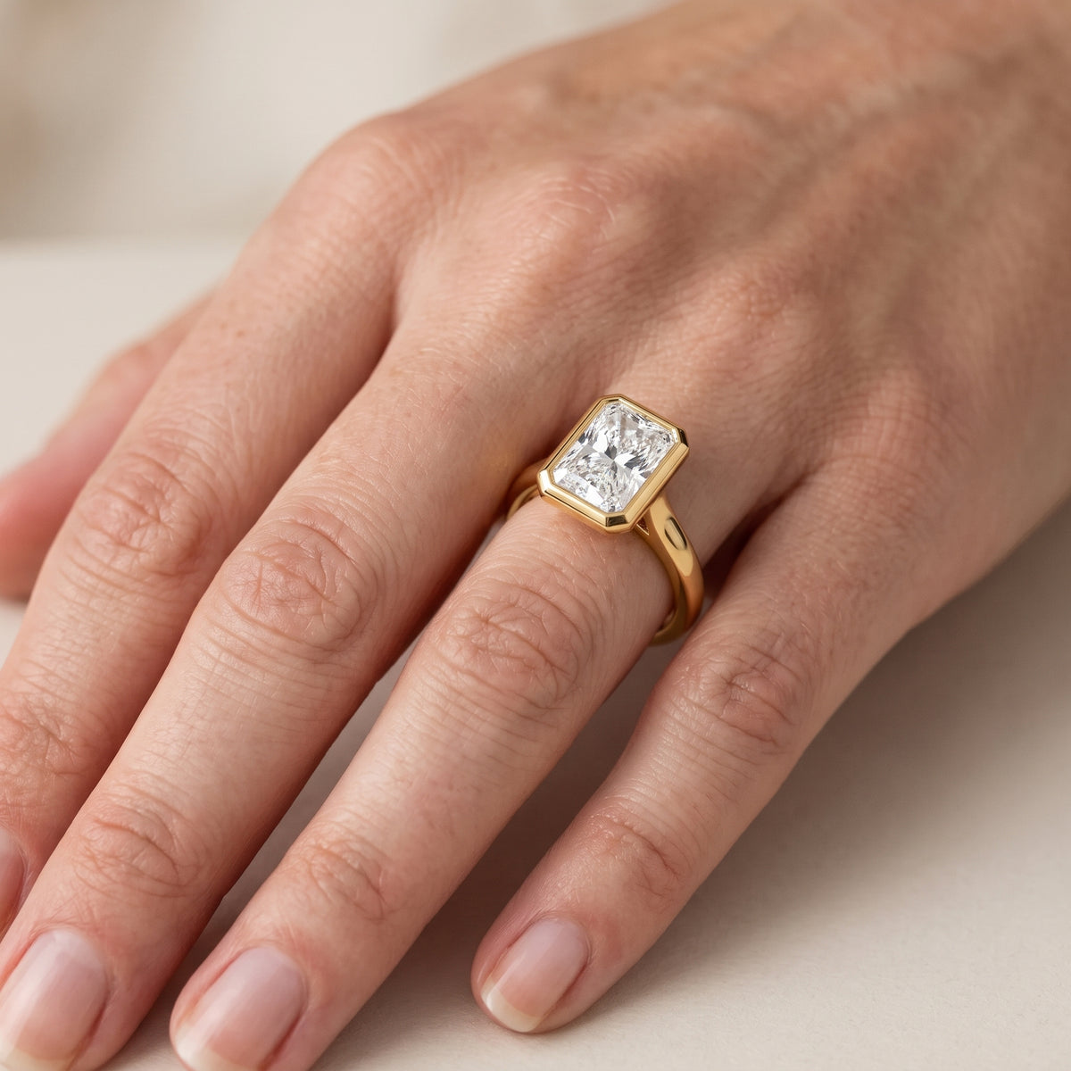 Jolie Bezel Solitaire Radiant Diamond Engagement Ring in Yellow Gold - lifestyle.jpg