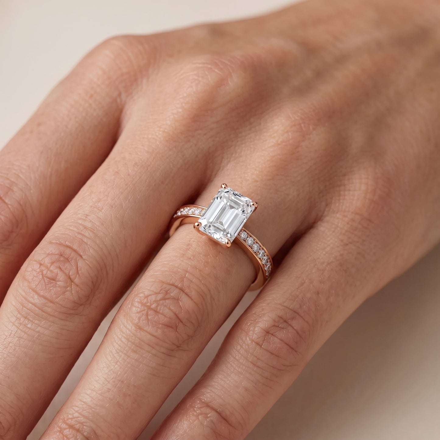 Rhea Sidestone Pavé Emerald Diamond Engagement Ring in Rose Gold - lifestyle.jpg