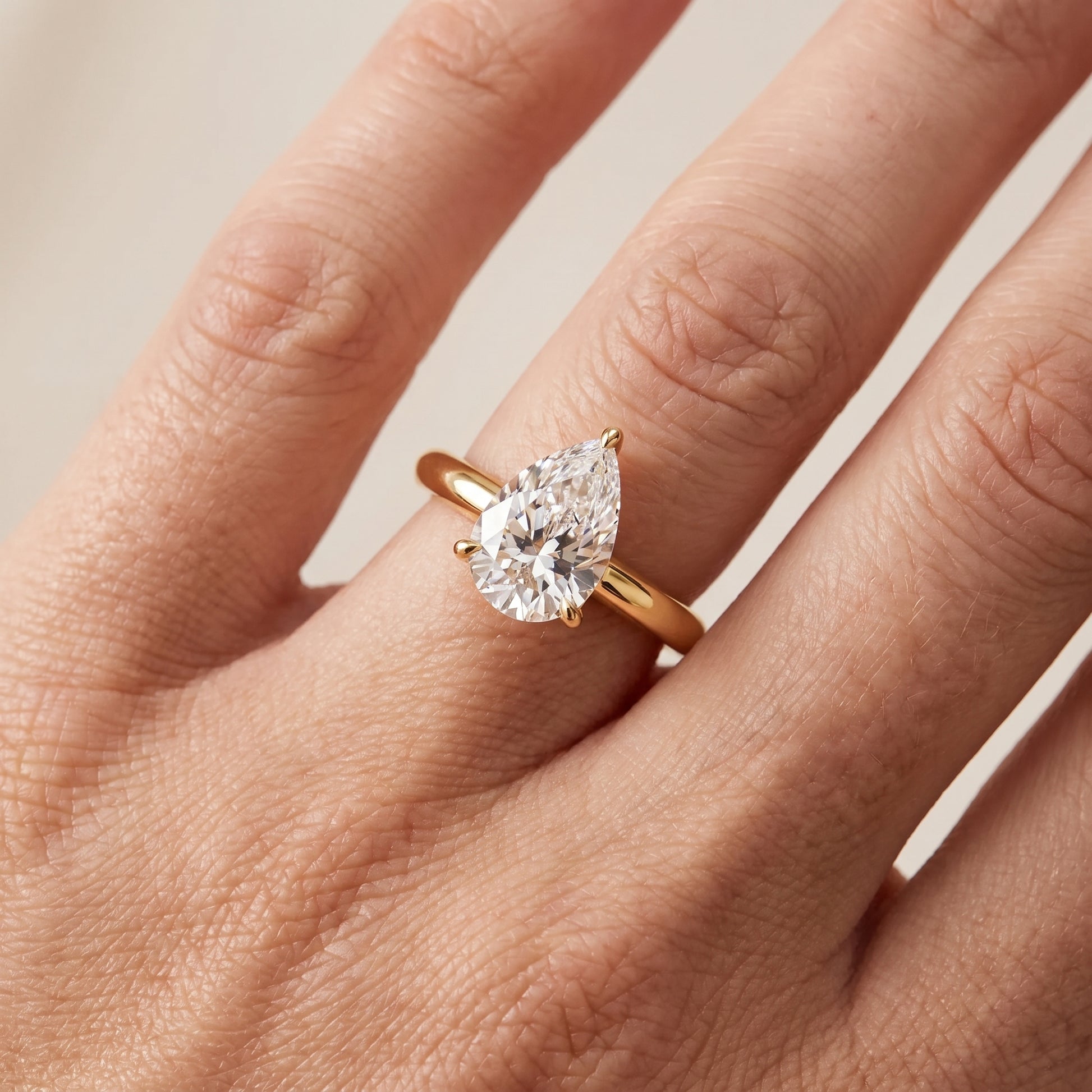 Kalia Knife Edge Solitaire Pear Diamond Engagement Ring in Yellow Gold - lifestyle.jpg