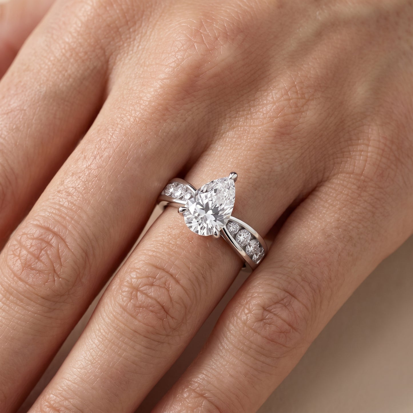 Noor Channel Set Sidestone Pear Diamond Engagement Ring in Silver - lifestyle.jpg