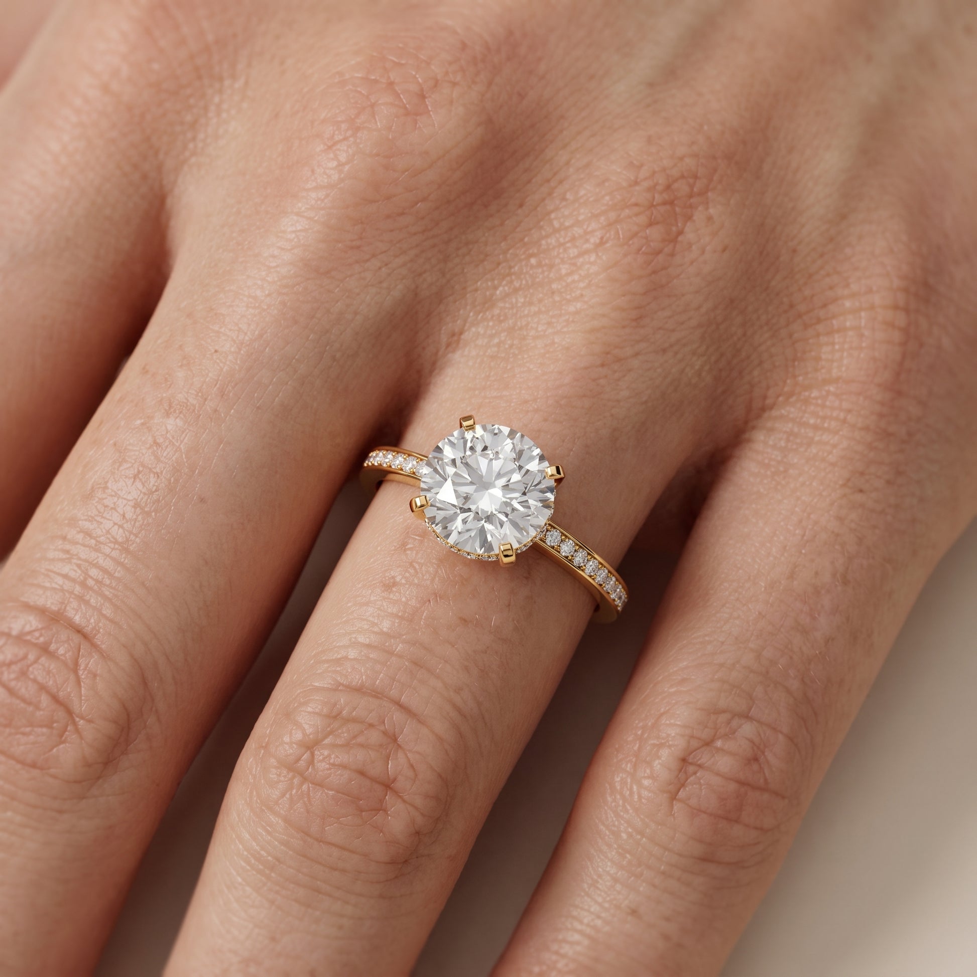 Naia Hidden Halo Round Diamond Ring in Yellow Gold - lifestyle.jpg
