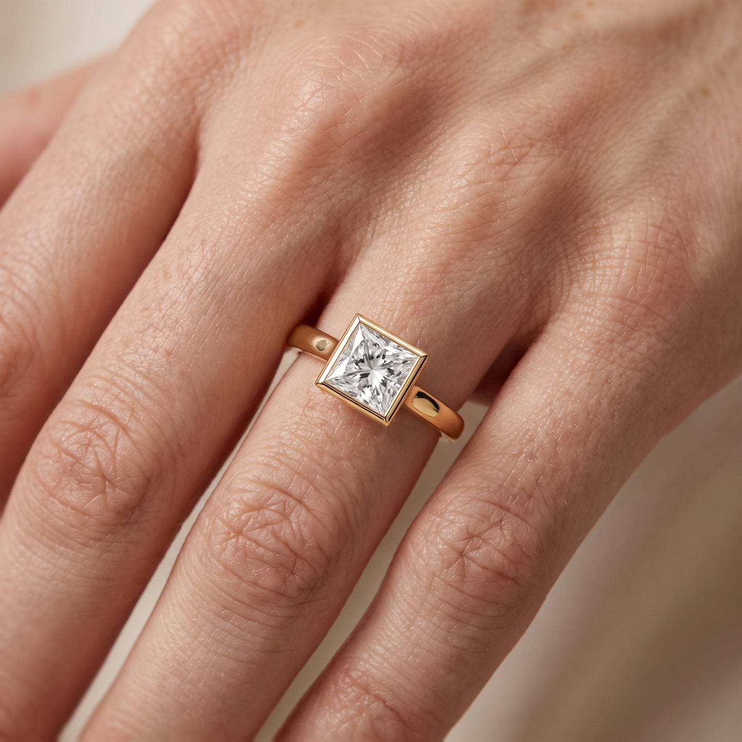 Jolie Bezel Solitaire Princess Diamond Engagement Ring in Yellow Gold - lifestyle.jpg