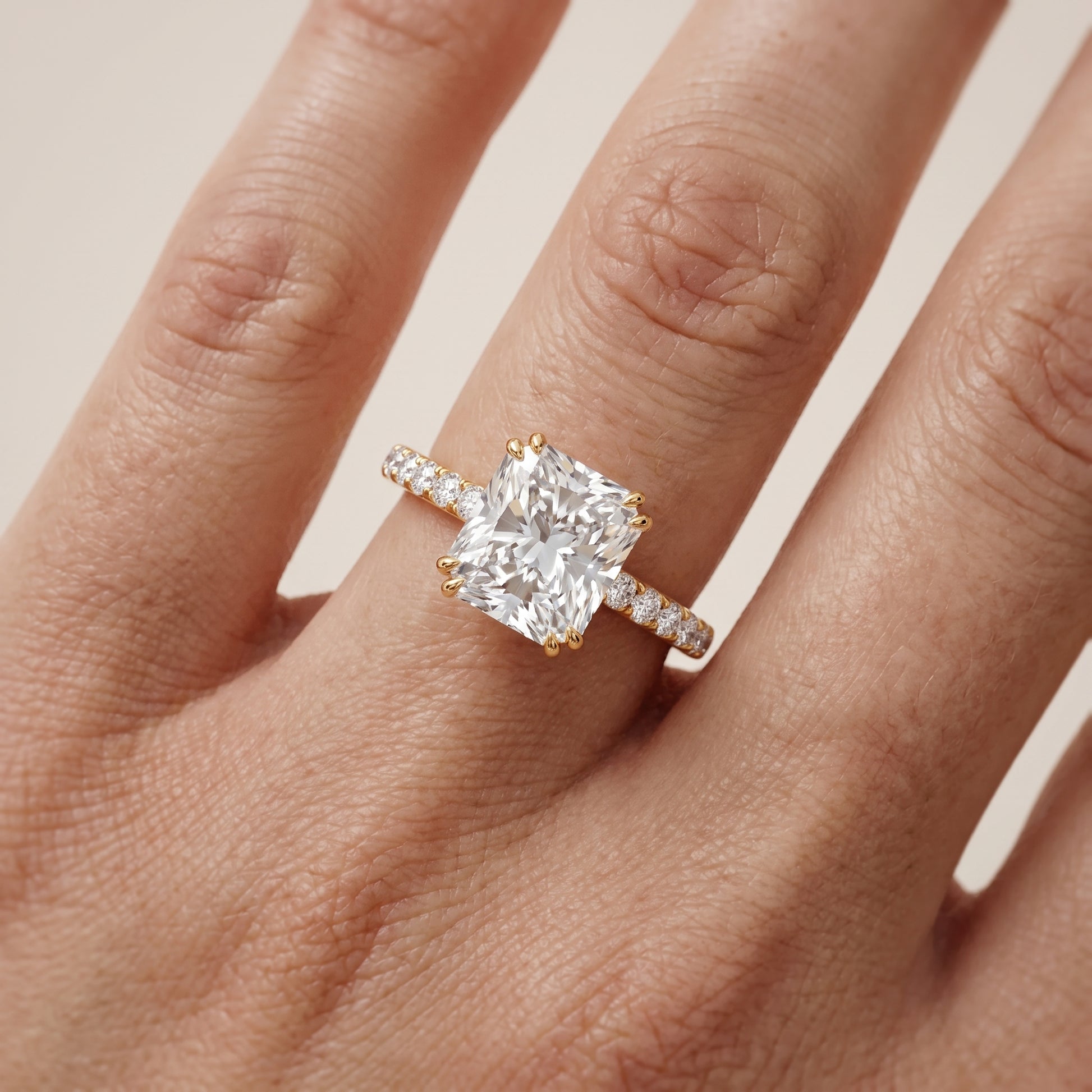 Novara Solitaire Pavé Radiant Diamond Ring in Yellow Gold - lifestyle.jpg