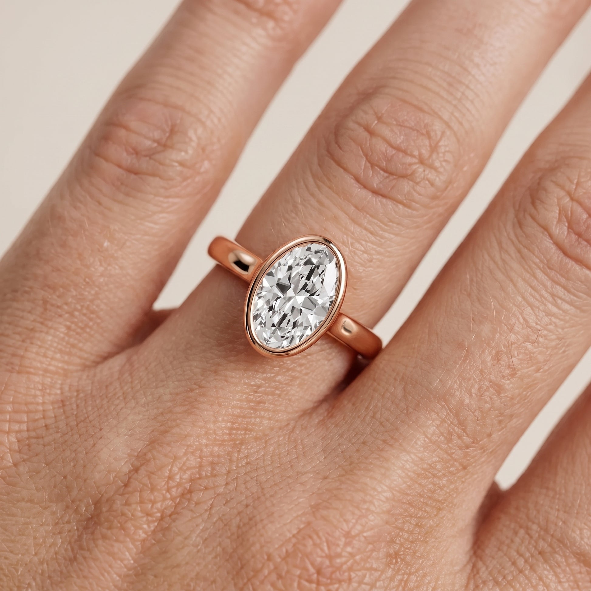 Jolie Bezel Solitaire Oval Diamond Engagement Ring in Rose Gold - lifestyle.jpg