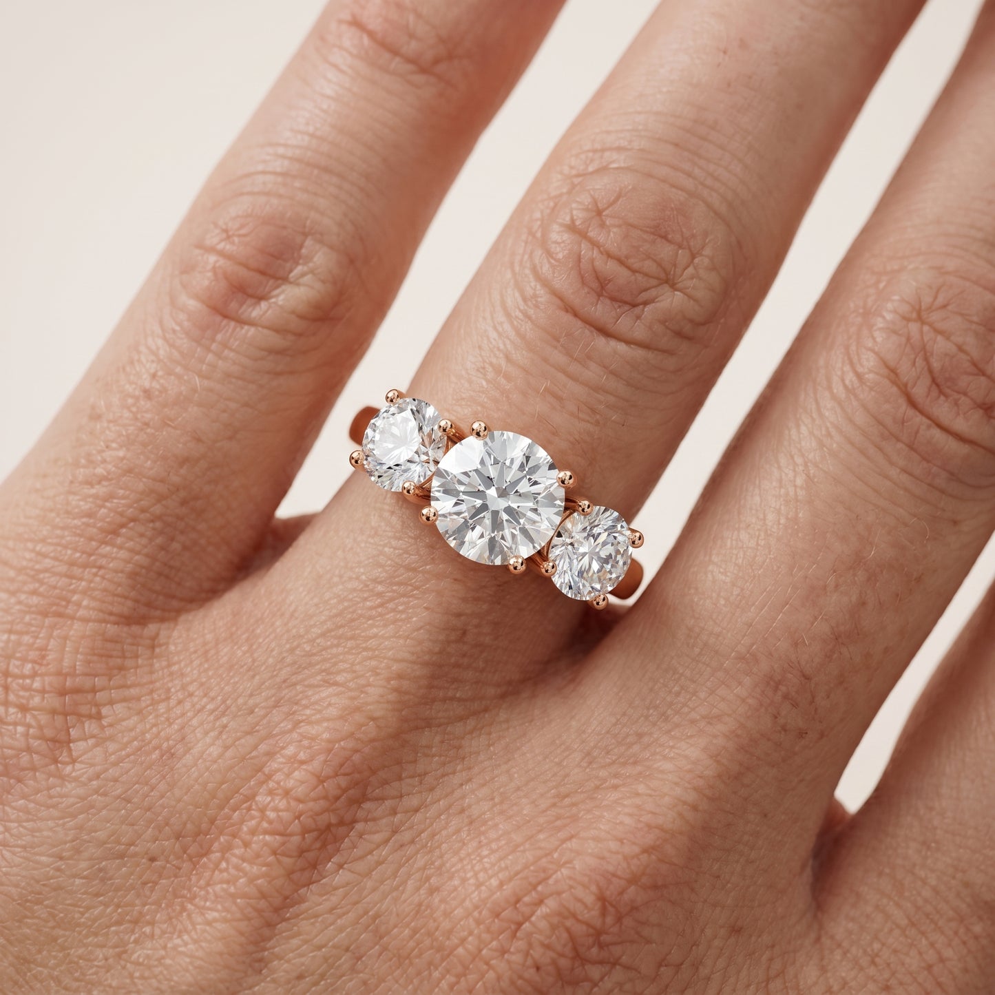 Esme Three-Stone Tapered Round Diamond Ring in Rose Gold - lifestyle.jpg