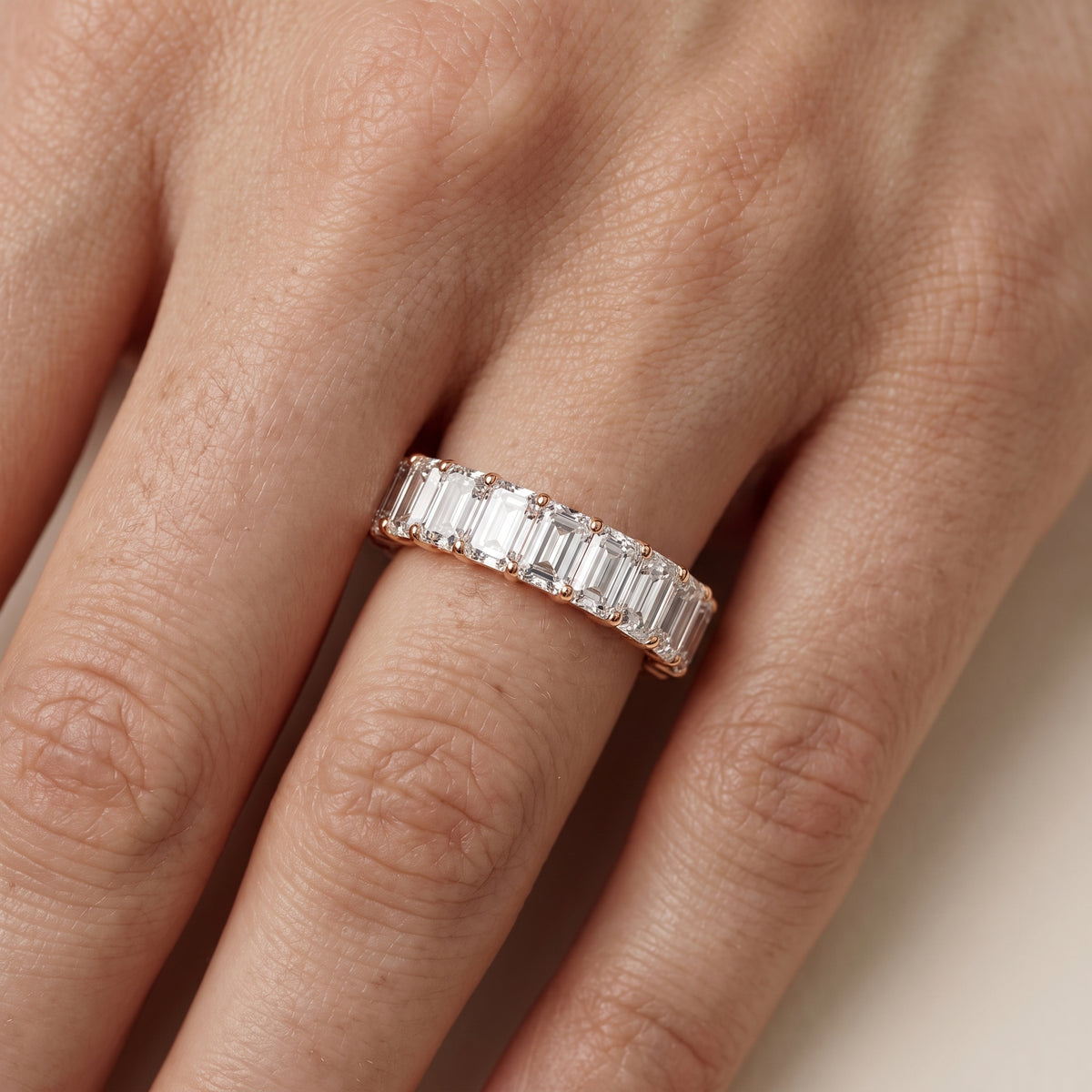 Florence Shared Prong Emerald Diamond Eternity Band in Rose Gold - lifestyle.jpg