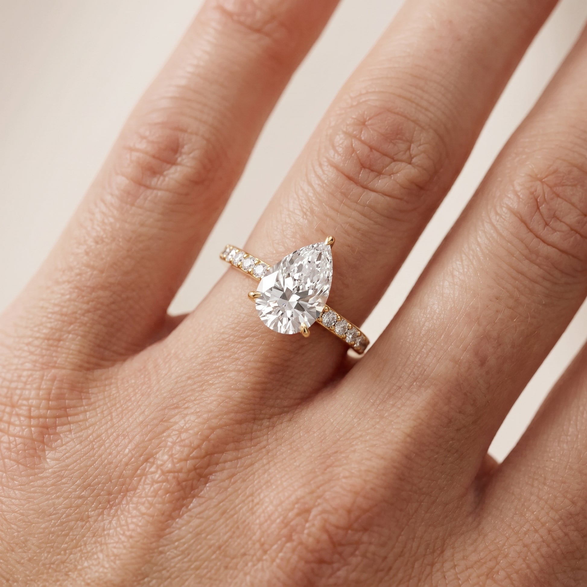 Aisha Pavé Solitaire Pear Diamond Engagement Ring in Yellow Gold - lifestyle.jpg