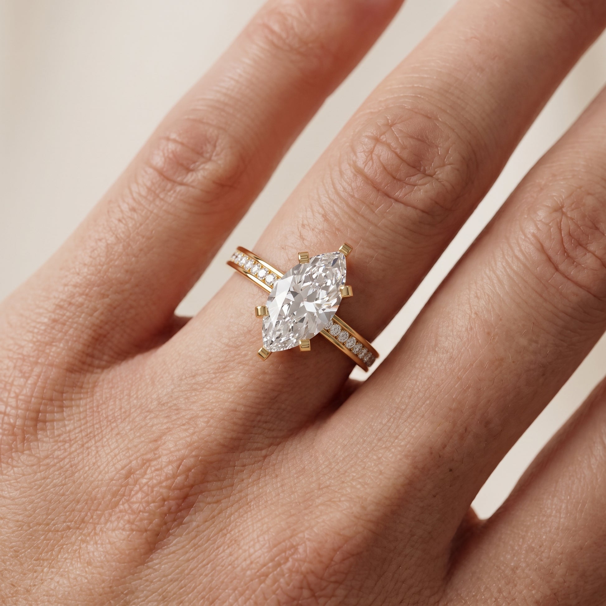 Tessa Solitaire Channel Set Marquise Diamond Engagement Ring in Yellow Gold - lifestyle.jpg