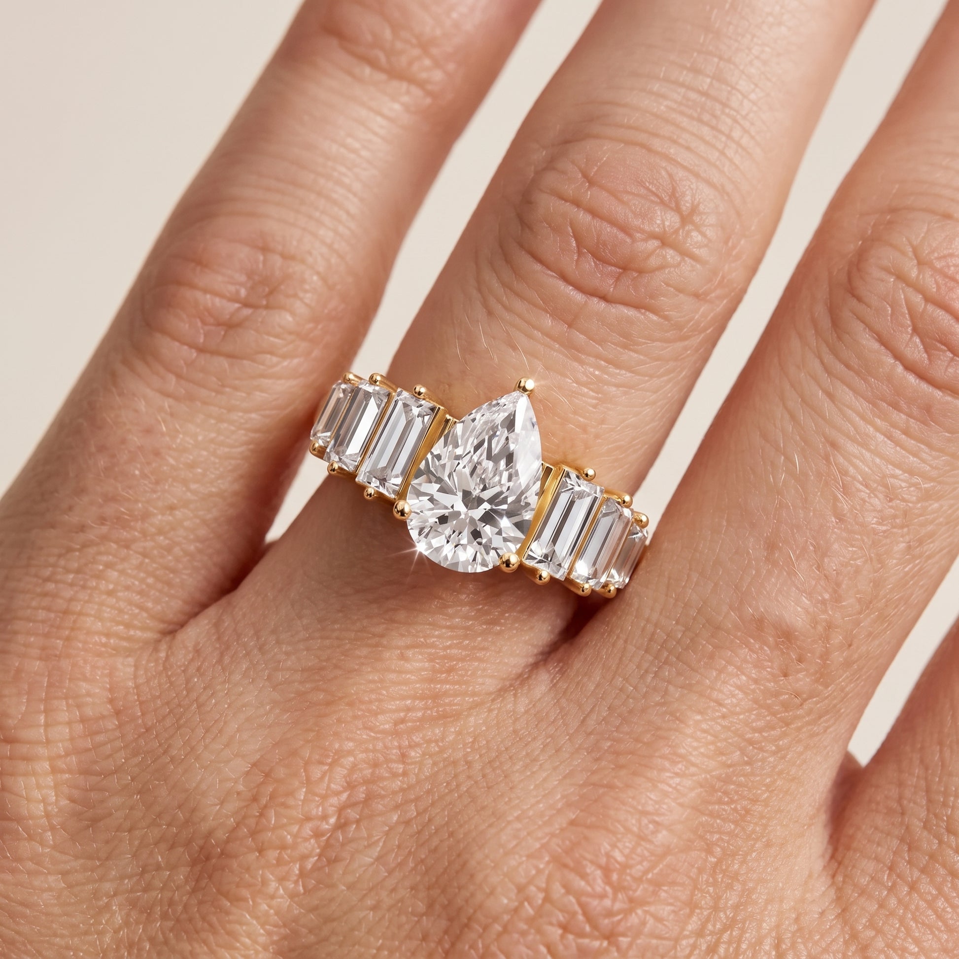Mara Sidestone Baguette Accent Pear Diamond Engagement Ring in Yellow Gold - lifestyle.jpg