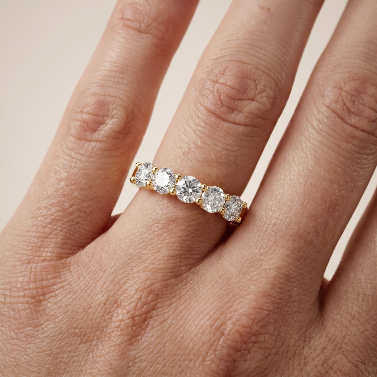 Cecilia Shared Prong Round Diamond Wedding Band in Yellow Gold - lifestyle.jpg