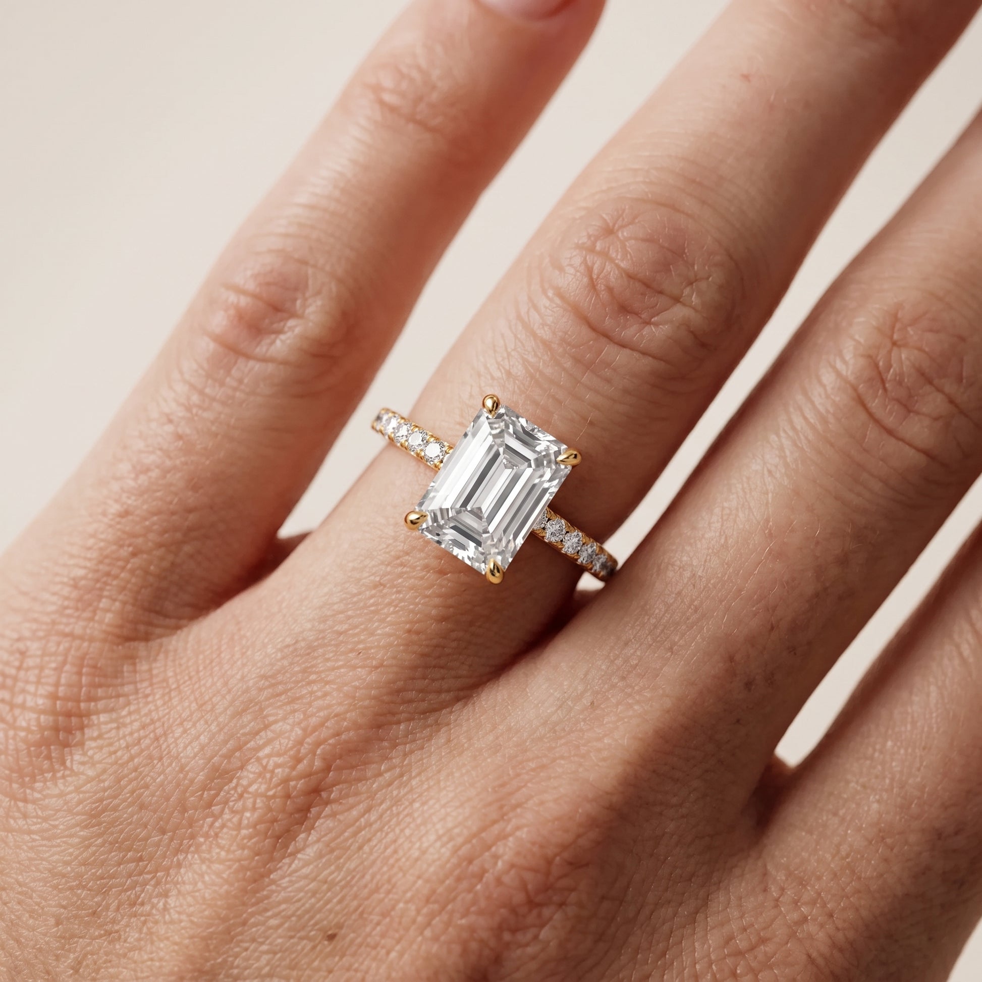 Ione Solitaire Pavé Emerald Diamond Engagement Ring in Yellow Gold - lifestyle.jpg