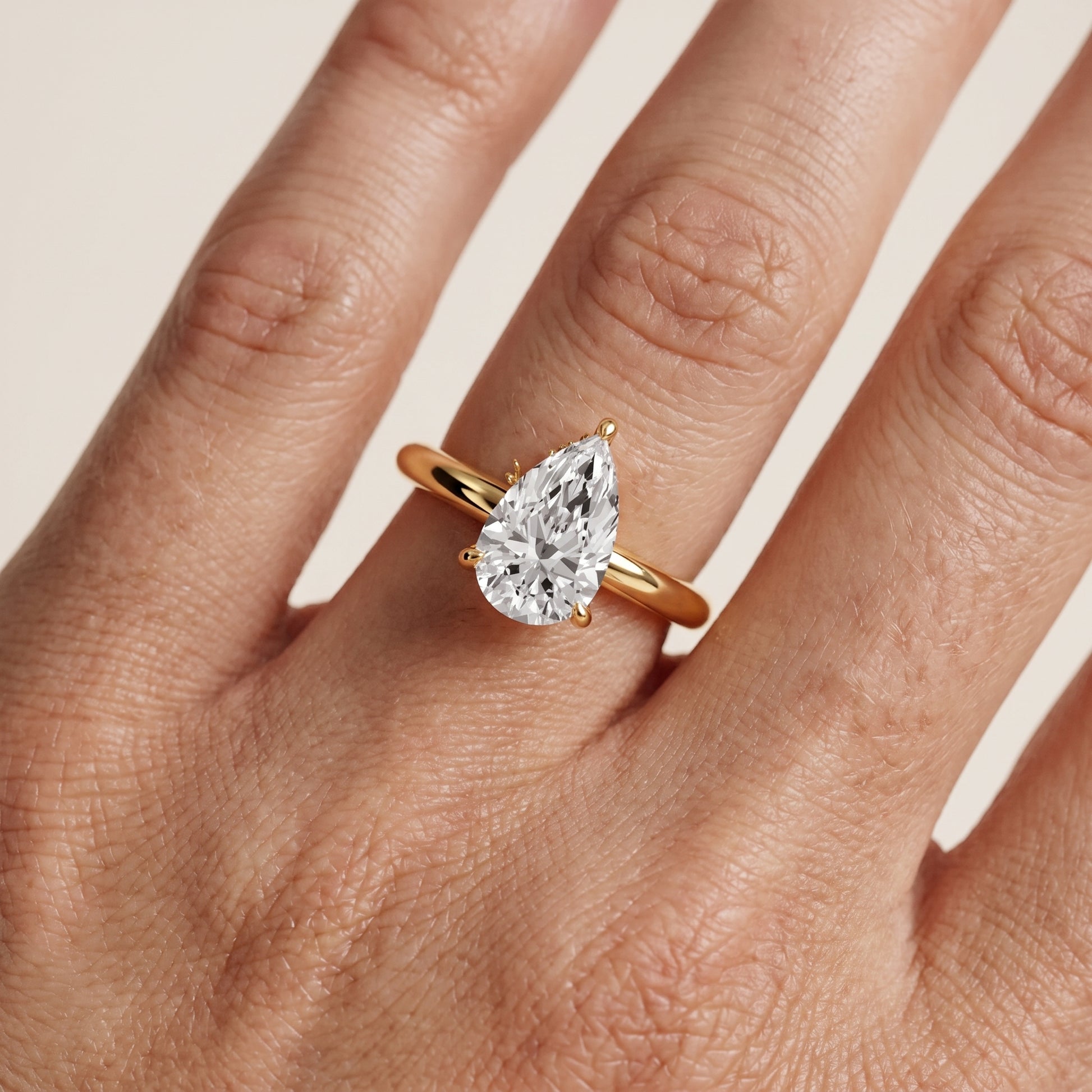 Amaya Hidden Halo Pear Diamond Ring in Yellow Gold - lifestyle.jpg