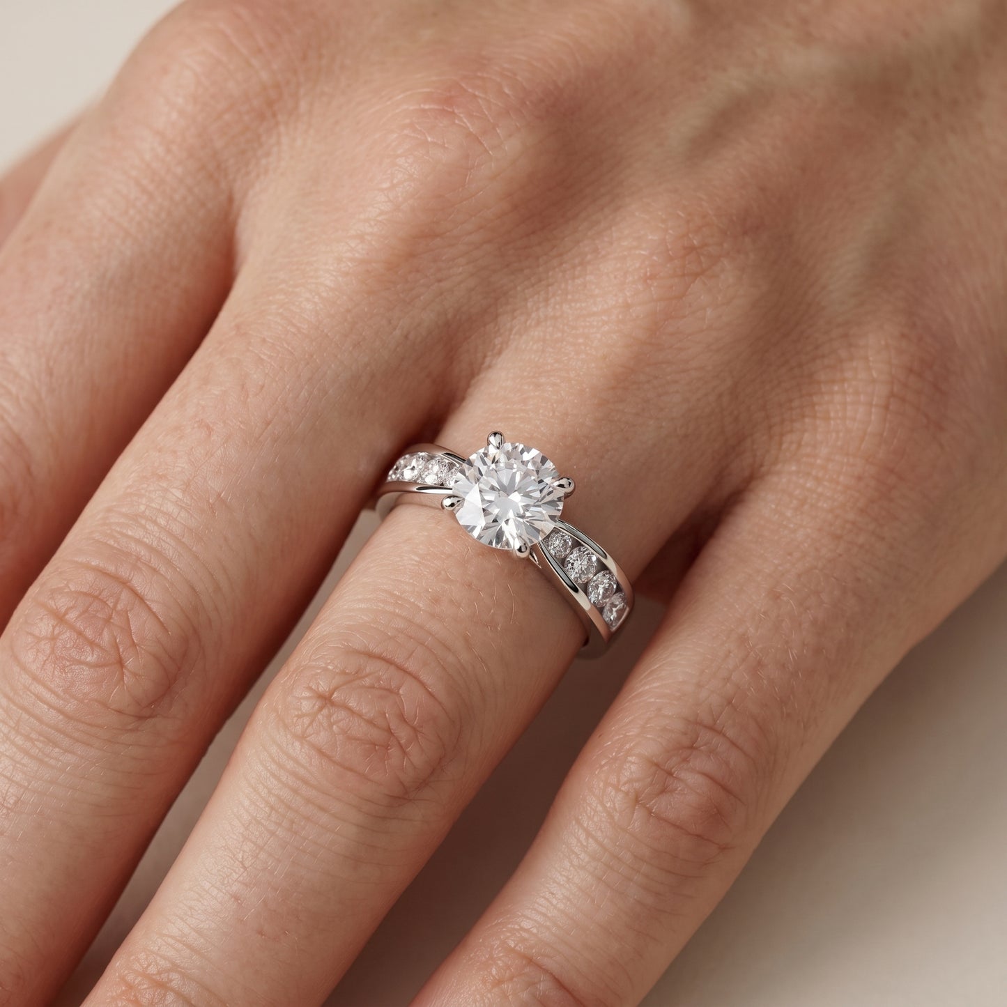 Noor Channel Set Sidestone Round Diamond Engagement Ring in White Gold - lifestyle.jpg