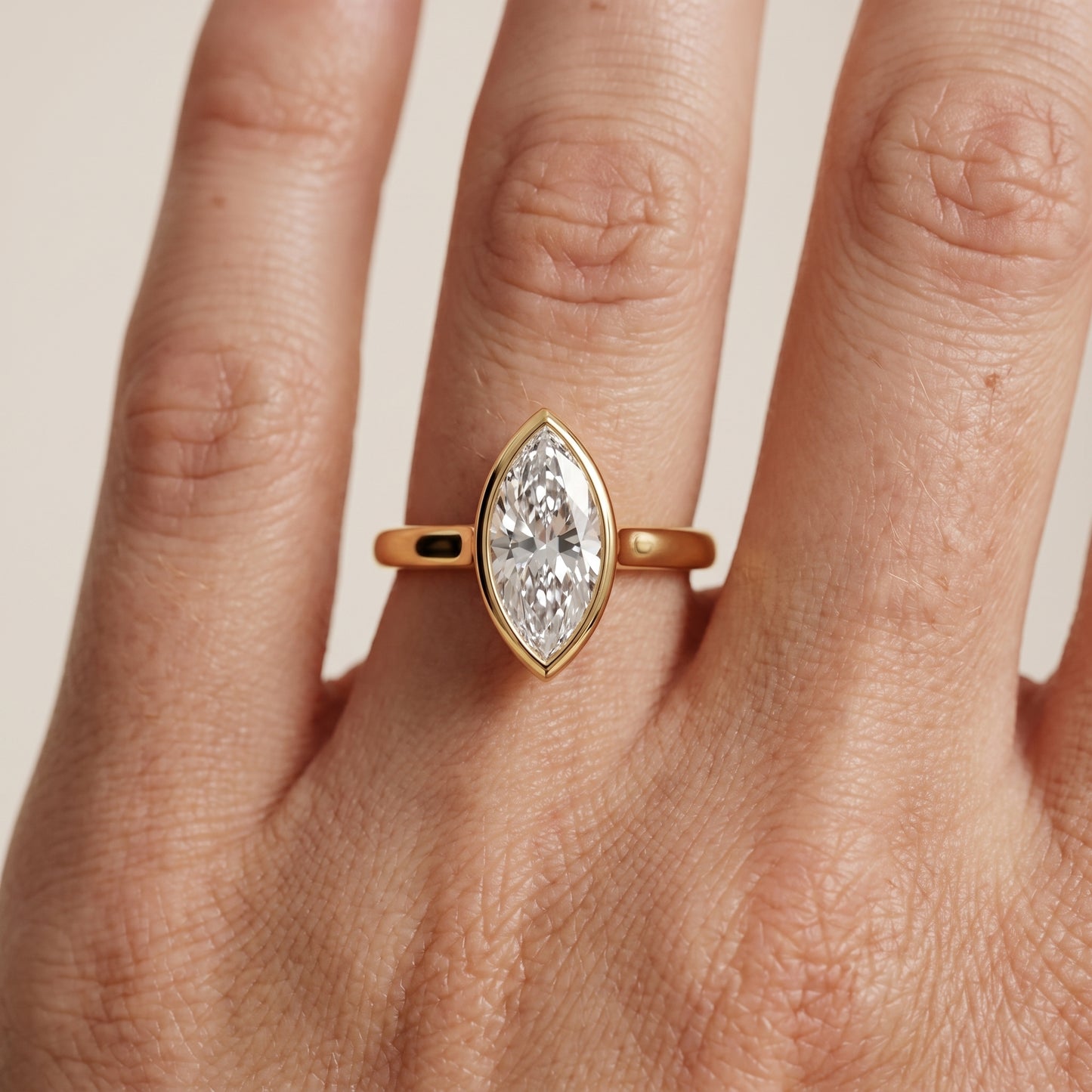 Jolie Bezel Solitaire Marquise Diamond Engagement Ring in Yellow Gold - lifestyle.jpg