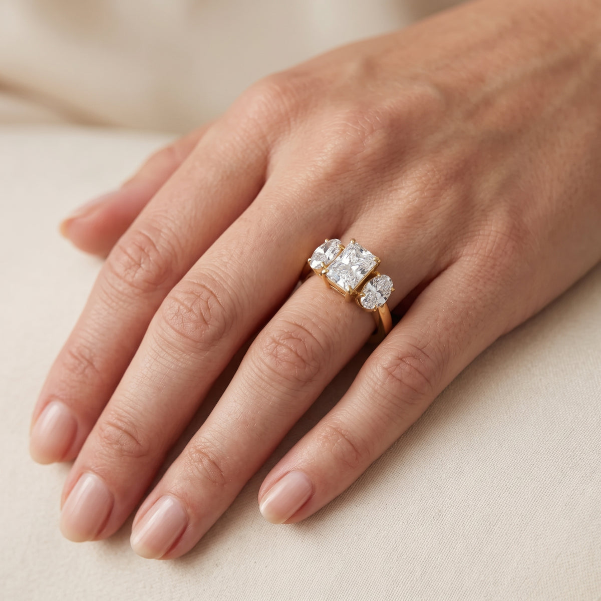 Lila Three-Stone Radiant Diamond Engagement Ring in Yellow Gold - lifestyle.jpg