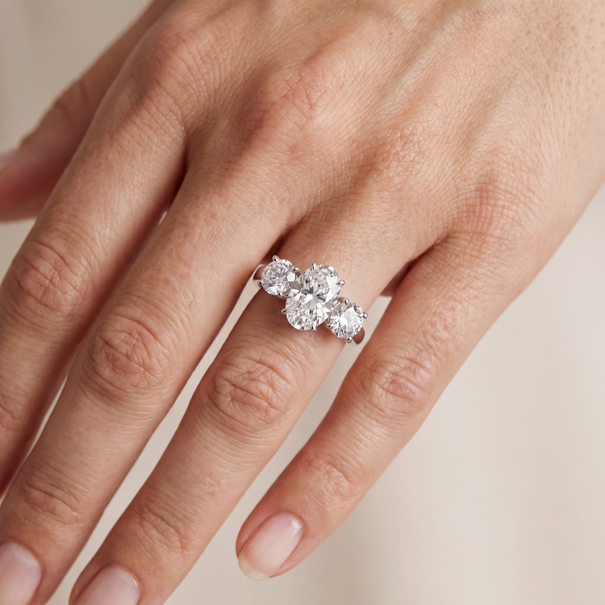 Esme Three-Stone Tapered Oval Diamond Ring in Platinum - lifestyle.jpg