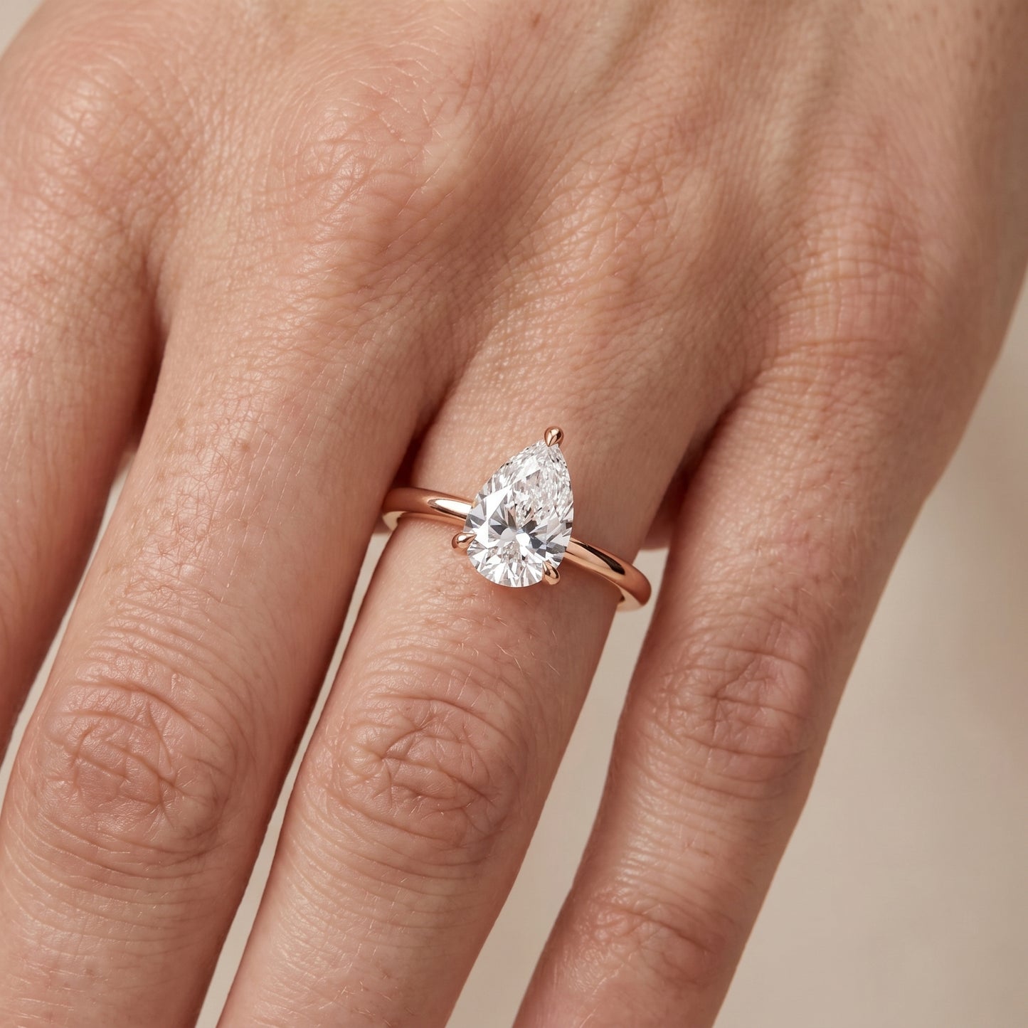 Nella Petite Solitaire Pear Diamond Engagement Ring in Rose Gold - lifestyle.jpg
