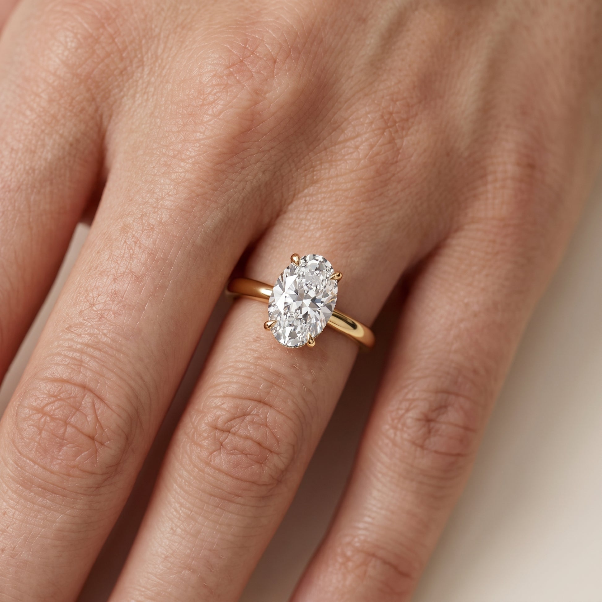 Mena Hidden Halo Oval Diamond Engagement Ring in Yellow Gold - lifestyle.jpg