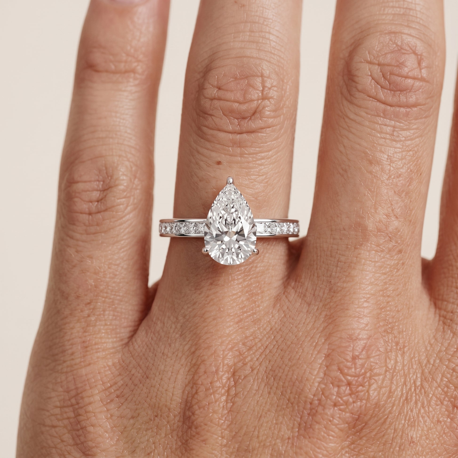 Brielle Channel Set Solitaire Pear Diamond Ring in Platinum - lifestyle.jpg