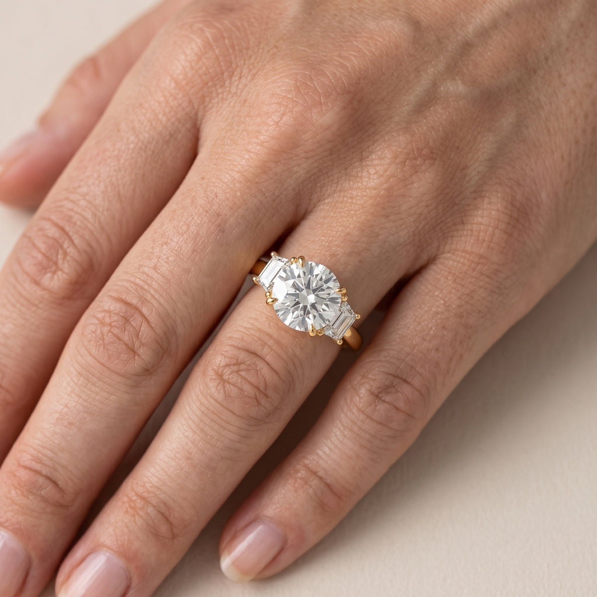 Federica Trapezoid Three-Stone Round Diamond Engagement Ring in Rose Gold - lifestyle.jpg