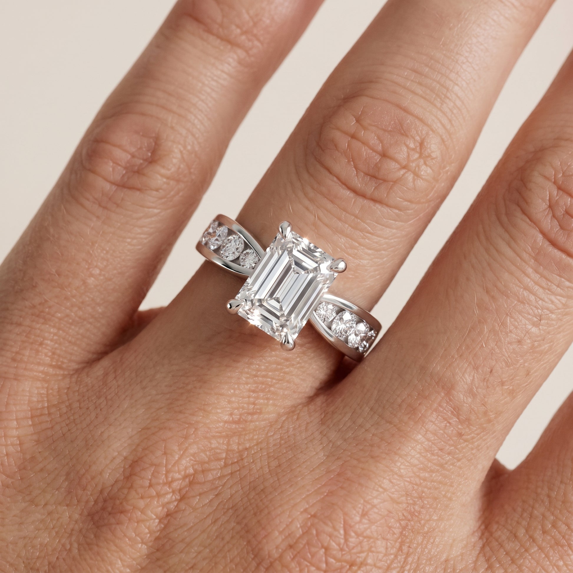 Noor Channel Set Sidestone Emerald Diamond Engagement Ring in Platinum - lifestyle.jpg