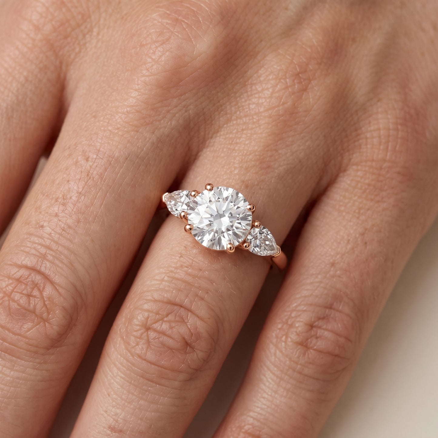 Mirabel Three-Stone Round Diamond Engagement Ring in Rose Gold - lifestyle.jpg
